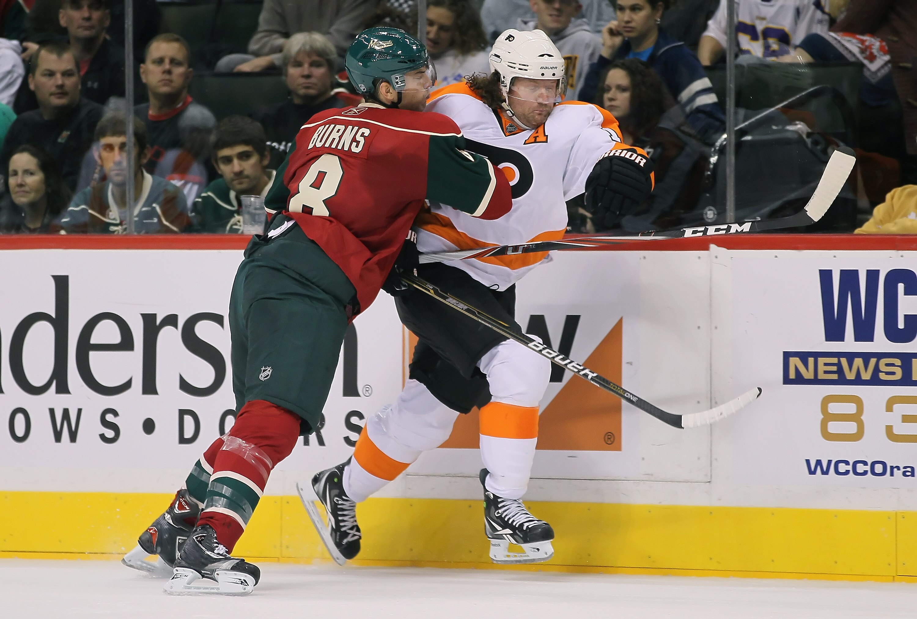 ST PAUL, MN - SEPTEMBER 25:  Scott Hartnell #19 of the Philadelphia Flyers is checked into the boards by Brent Burns #8 of the Minnesota Wild during the third period at Xcel Energy Center on September 25, 2010 in St Paul, Minnesota. The Flyers defeated th