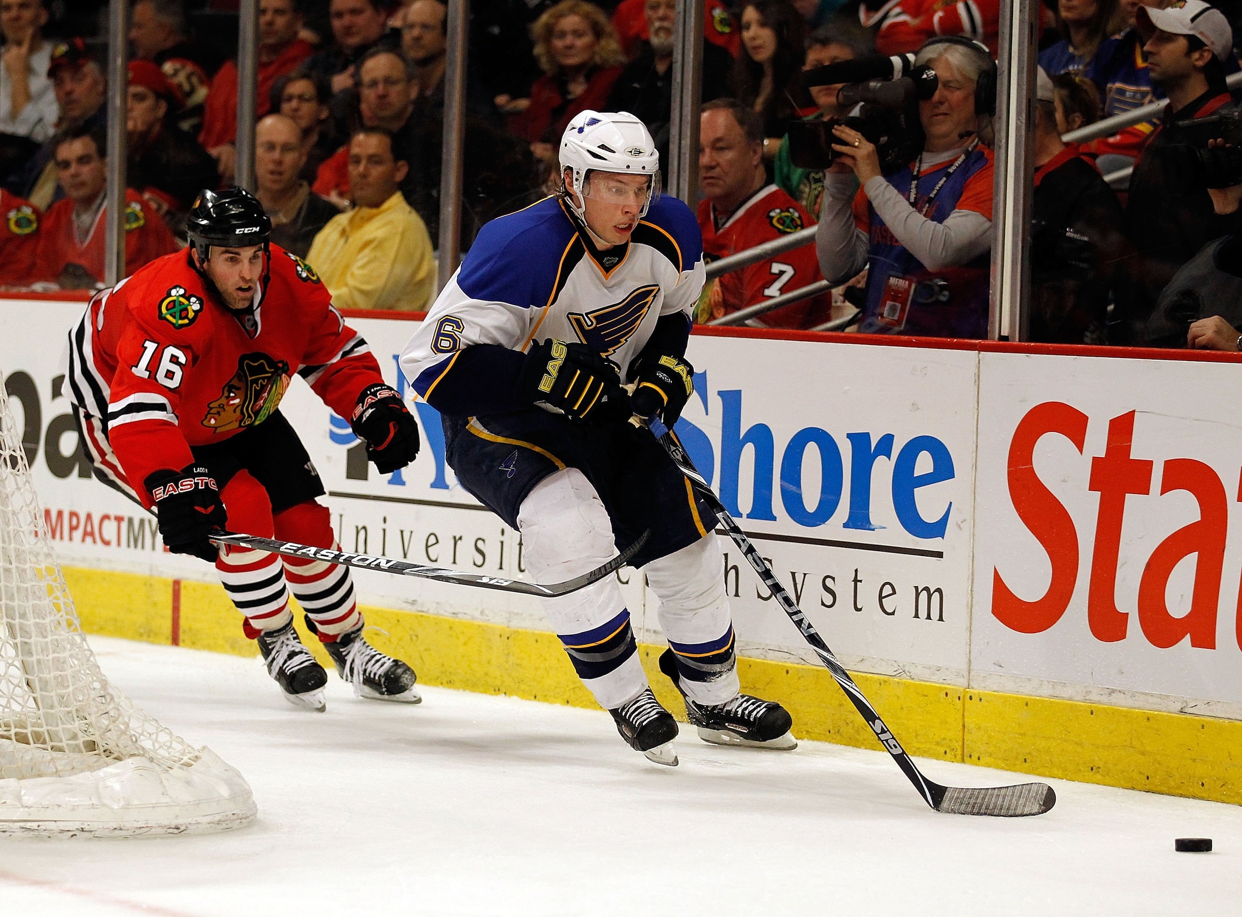 CHICAGO - APRIL 07: Erik Johnson #6 of the St. Louis Blues chases down the puck pursued by Andrew Ladd #16 of the Chicago Blackhawks at the United Center on April 7, 2010 in Chicago, Illinois. The Blackhawks defeated the Blues 6-5. (Photo by Jonathan Dani