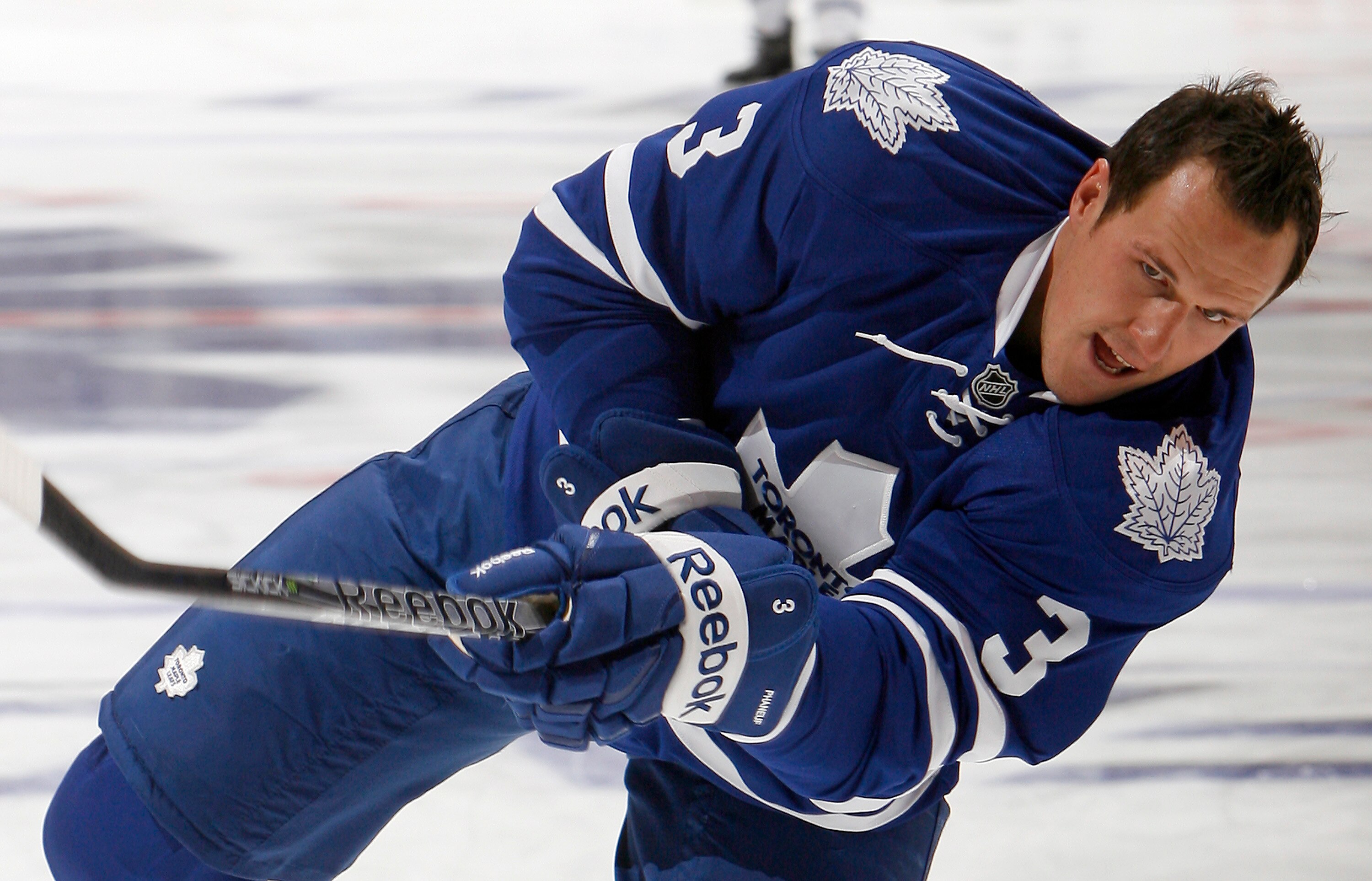 TORONTO - OCTOBER 7: First game as new Leafs Captain Dion Phaneuf #3 of the Toronto Maple Leafs shoots during warmup before playing the Montreal Canadiens during a regular season NHL game against the Toronto Maple Leafs at the Air Canada Centre October 7,