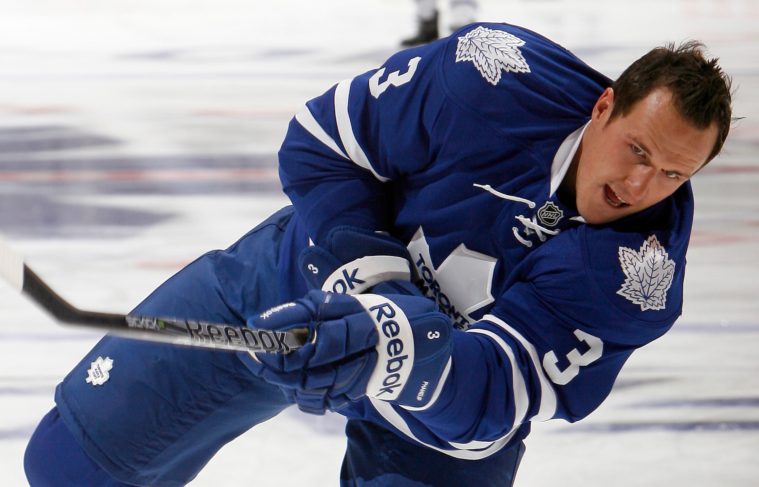 TORONTO - OCTOBER 7: First game as new Leafs Captain Dion Phaneuf #3 of the Toronto Maple Leafs shoots during warmup before playing the Montreal Canadiens during a regular season NHL game against the Toronto Maple Leafs at the Air Canada Centre October 7,