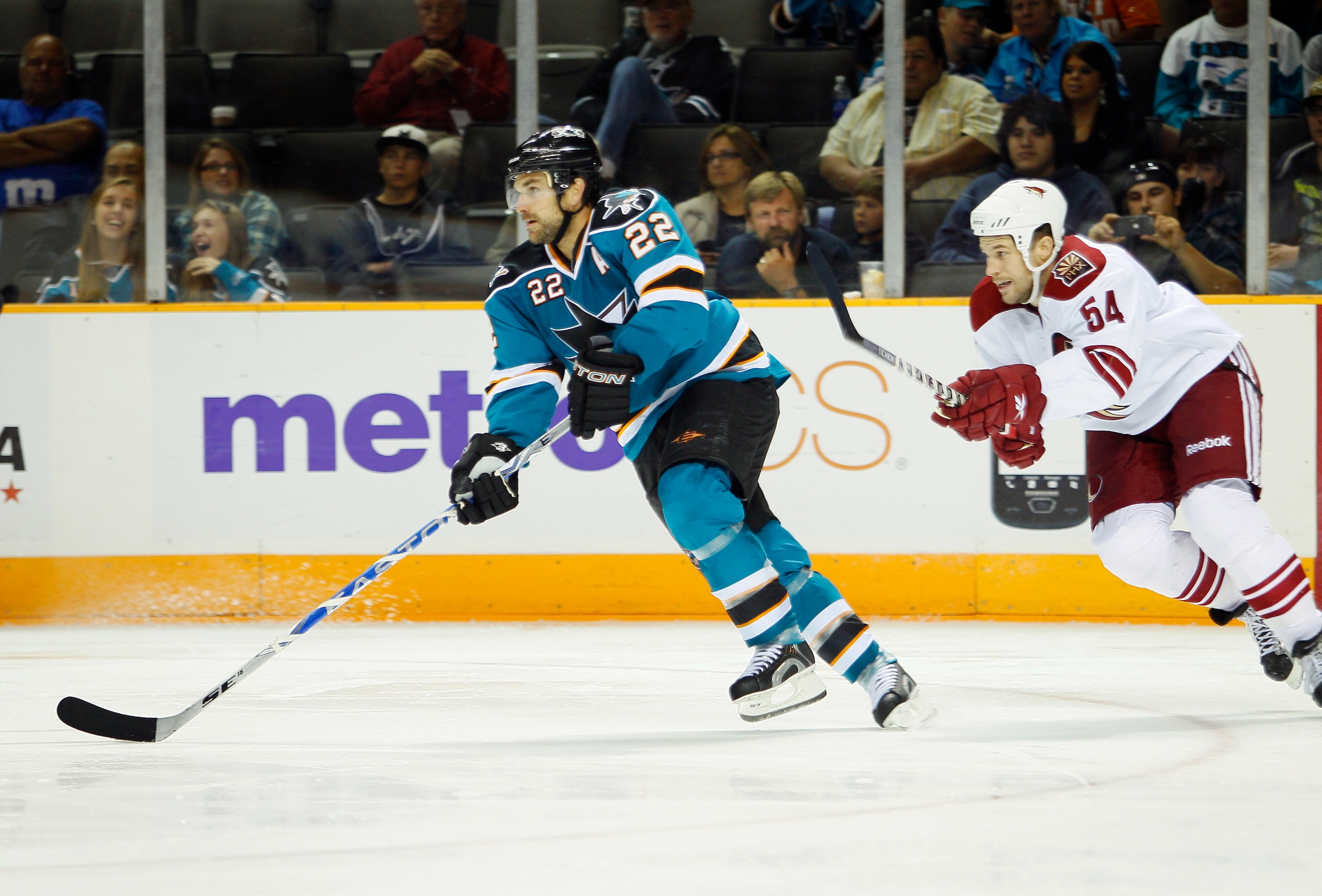 SAN JOSE, CA - SEPTEMBER 25:  Bracken Kearns #54 of the Phoenix Coyotes looks to catch up to Dan Boyle #22 of the San Jose Sharks in a preseason split-squad game at HP Pavilion on September 25, 2010 in San Jose, California.  The Sharks won 3-1.  (Photo by