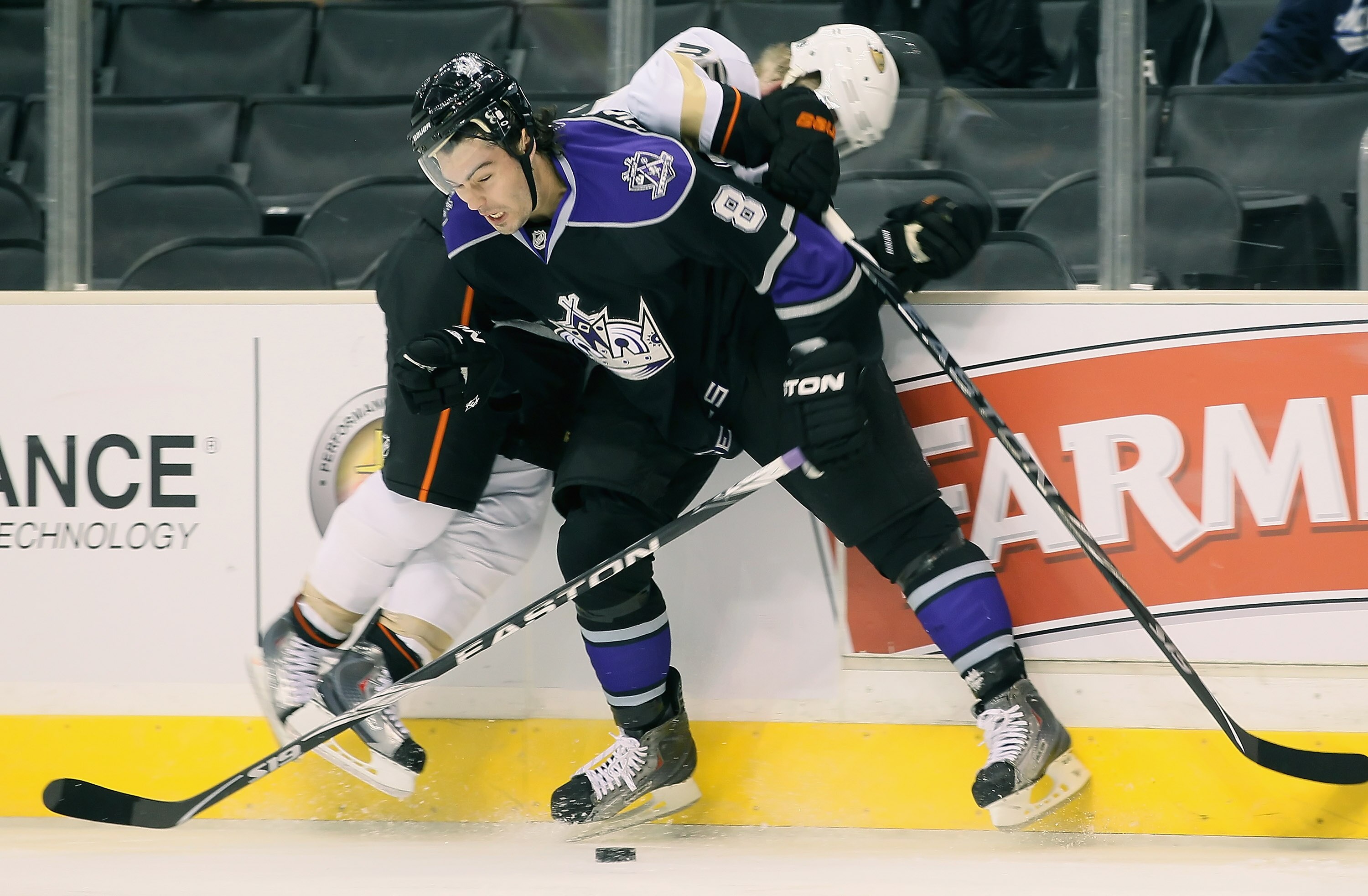 LOS ANGELES, CA - SEPTEMBER 28:  Jason Blake #33 of the Anaheim Ducks is checked into the boards by Drew Doughty #8 of the Los Angeles Kings at Staples Center on September 28, 2010 in Los Angeles, California.  (Photo by Jeff Gross/Getty Images)