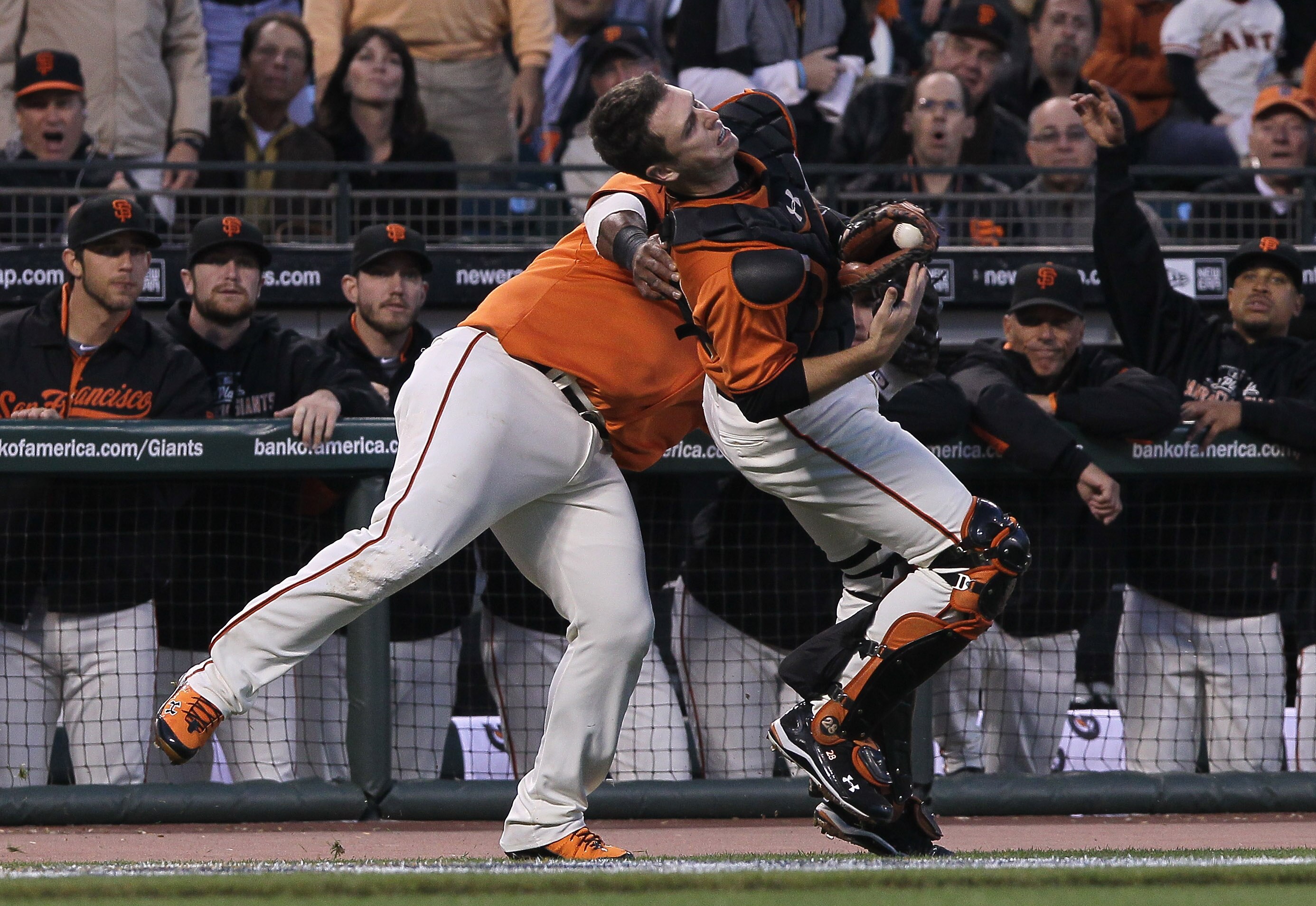 SAN FRANCISCO - OCTOBER 08:  Buster Posey #28 of the San Francisco Giants collides with Pablo Sandoval #48 trying to field a foul ball during the first inning of the National League Division Series with the Atlanta Braves at AT&T Park on October 8, 2010 i