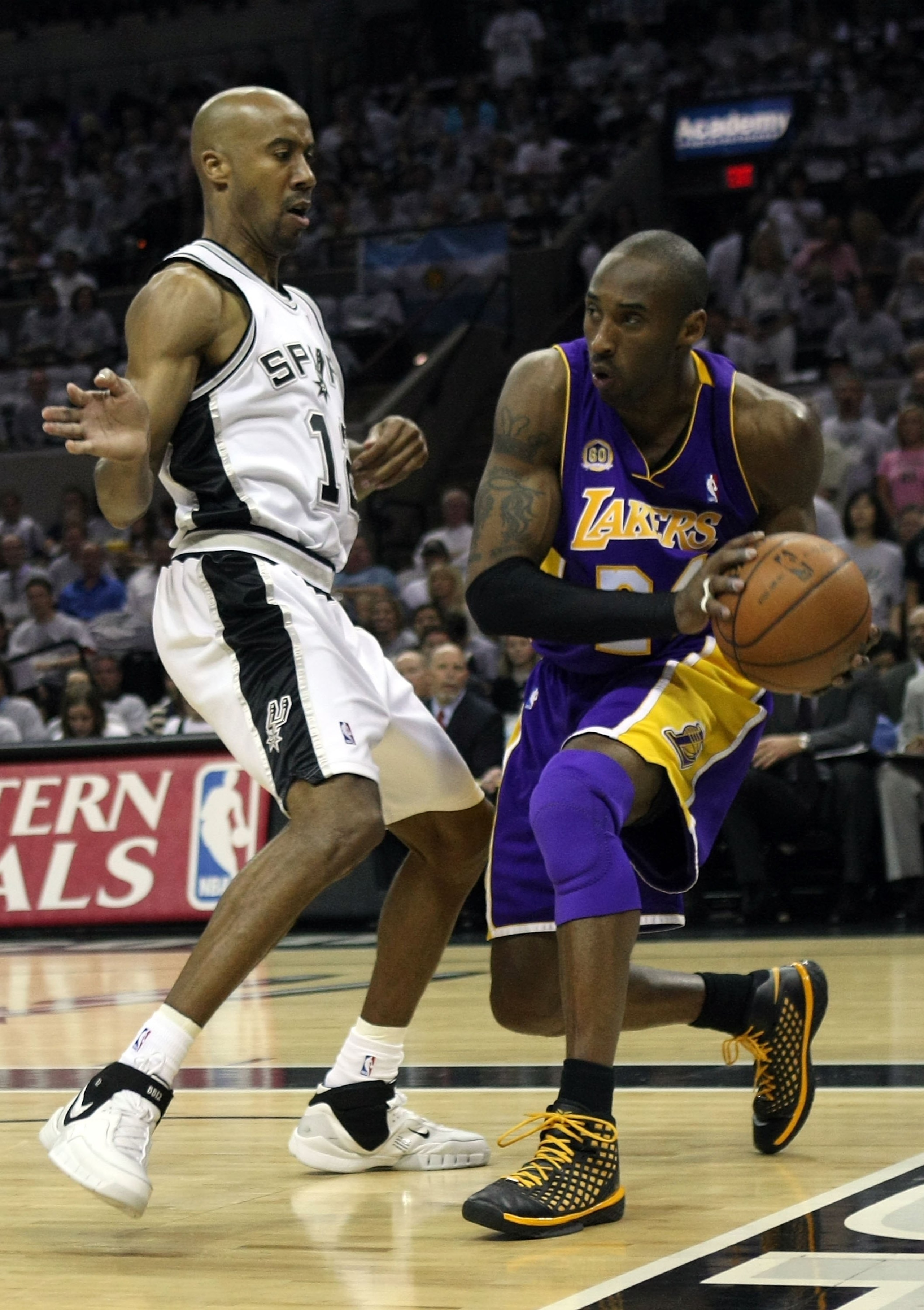 SAN ANTONIO - MAY 25:  Kobe Bryant #24 of the Los Angeles Lakers drives on Bruce Bowen #12 of the San Antonio Spurs in Game Three of the Western Conference Finals during the 2008 NBA Playoffs on May 25, 2008 at the AT&T Center in San Antonio, Texas. The S