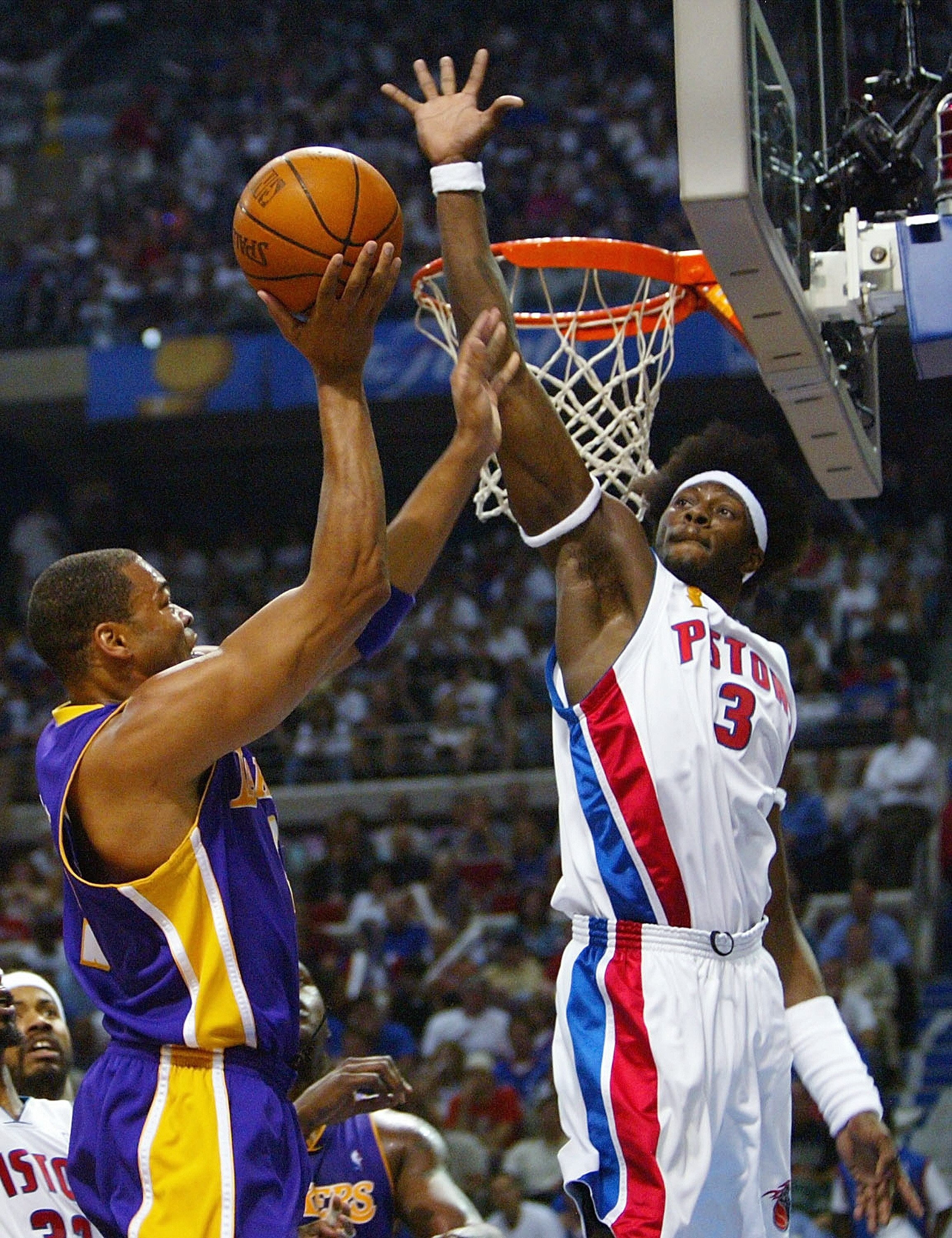 AUBURN HILLS, MI - JUNE 15:  Ben Wallace #3 of the Detroit Pistons attempts to block a shot by Devean George #3 of the Los Angeles Lakers during the second quarter in Game five of the 2004 NBA Finals on June 15, 2004 at The Palace of Auburn Hills in Aubur