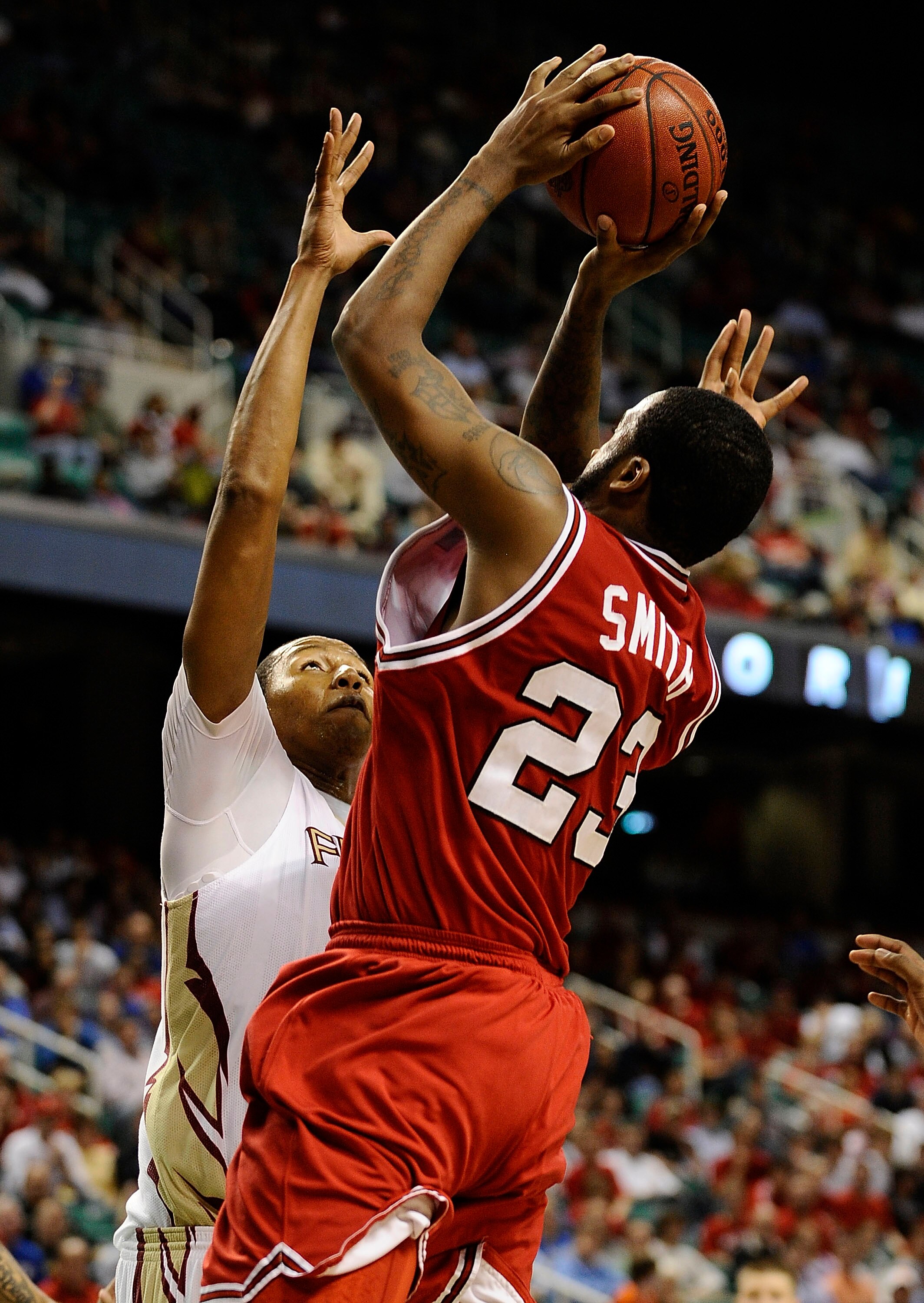 GREENSBORO, NC - MARCH 12:  Tracy Smith #23 of the North Carolina State Wolfpack shoots over Xavier Gibson #1 Florida State Seminoles in their quarterfinal game in the 2010 ACC Men's Basketball Tournament at the Greensboro Coliseum on March 12, 2010 in Gr
