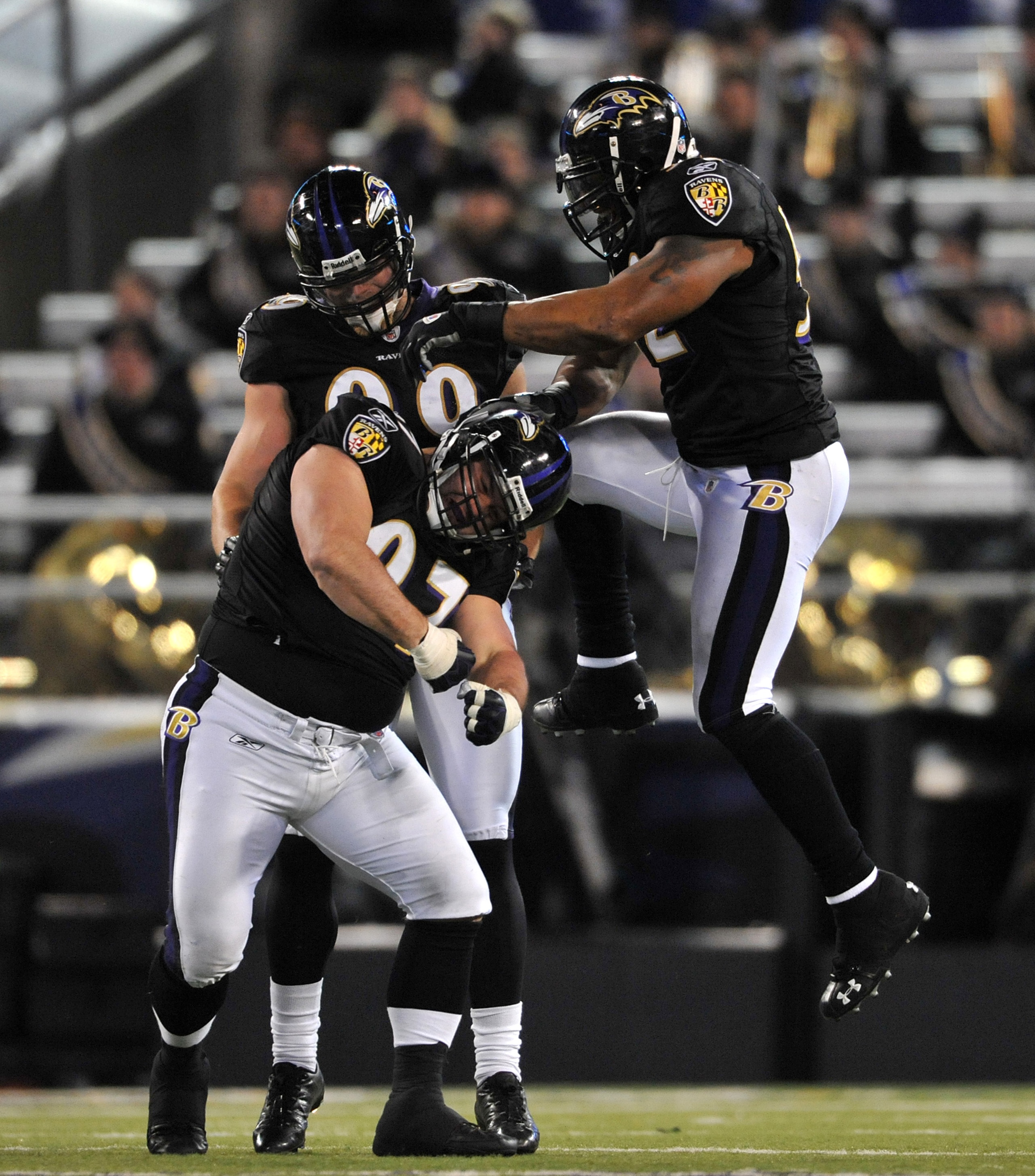 BALTIMORE - DECEMBER 20:  Ray Lewis #52, Kelly Gregg #97and Paul Kruger #99 of the Baltimore Ravens celebrate a play against the Chicago Bears at M&T Bank Stadium on December 20, 2009 in Baltimore, Maryland. The Ravens defeated the Bears 31-7. (Photo by L