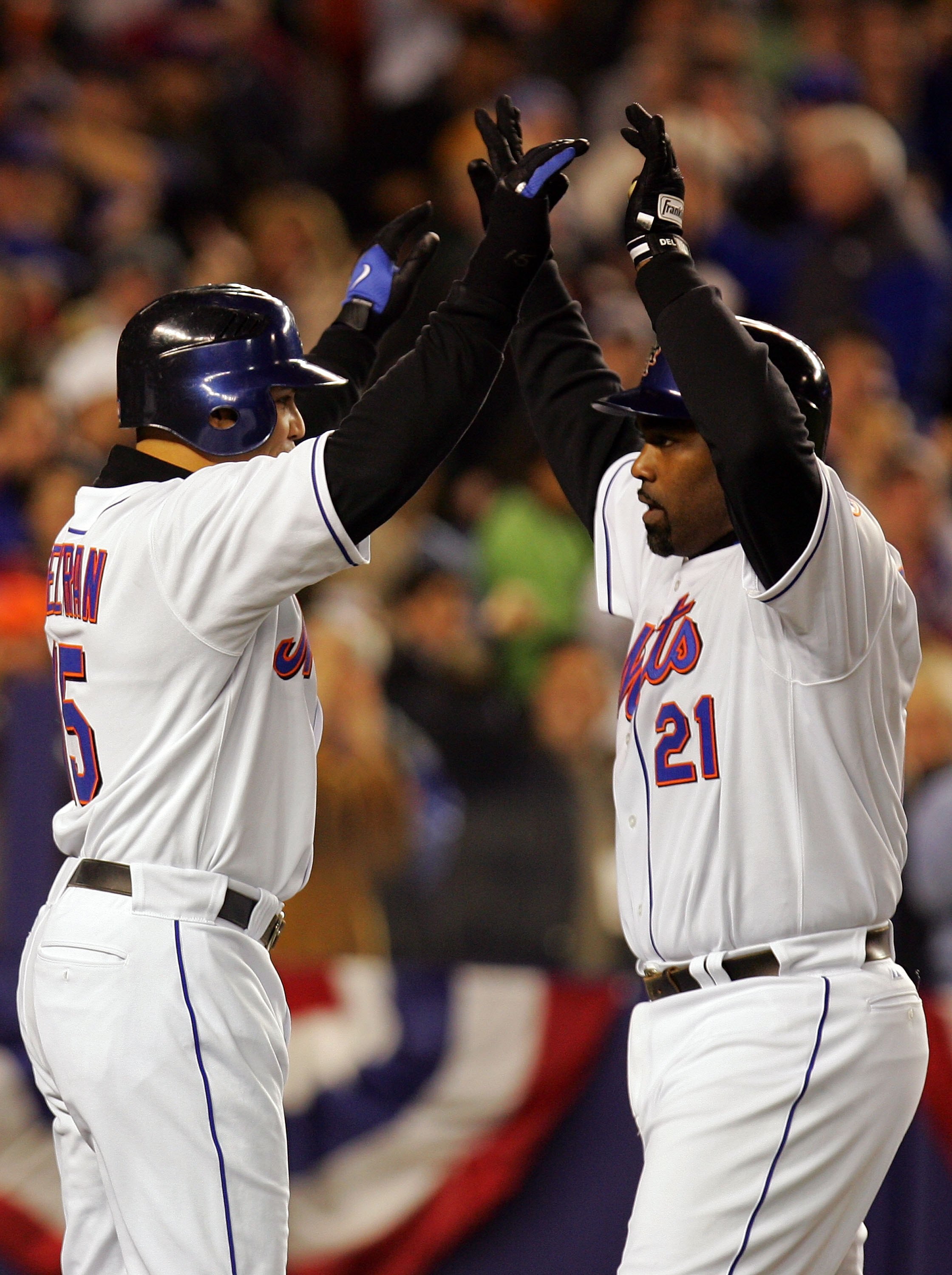 NEW YORK - OCTOBER 13:  Carlos Delgado #21 and Carlos Beltran #15 of the New York Mets celebrate Delgado's two-run home run in the first inning against the St. Louis Cardinals during game two of the NLCS at Shea Stadium on October 13, 2006 in the Flushing