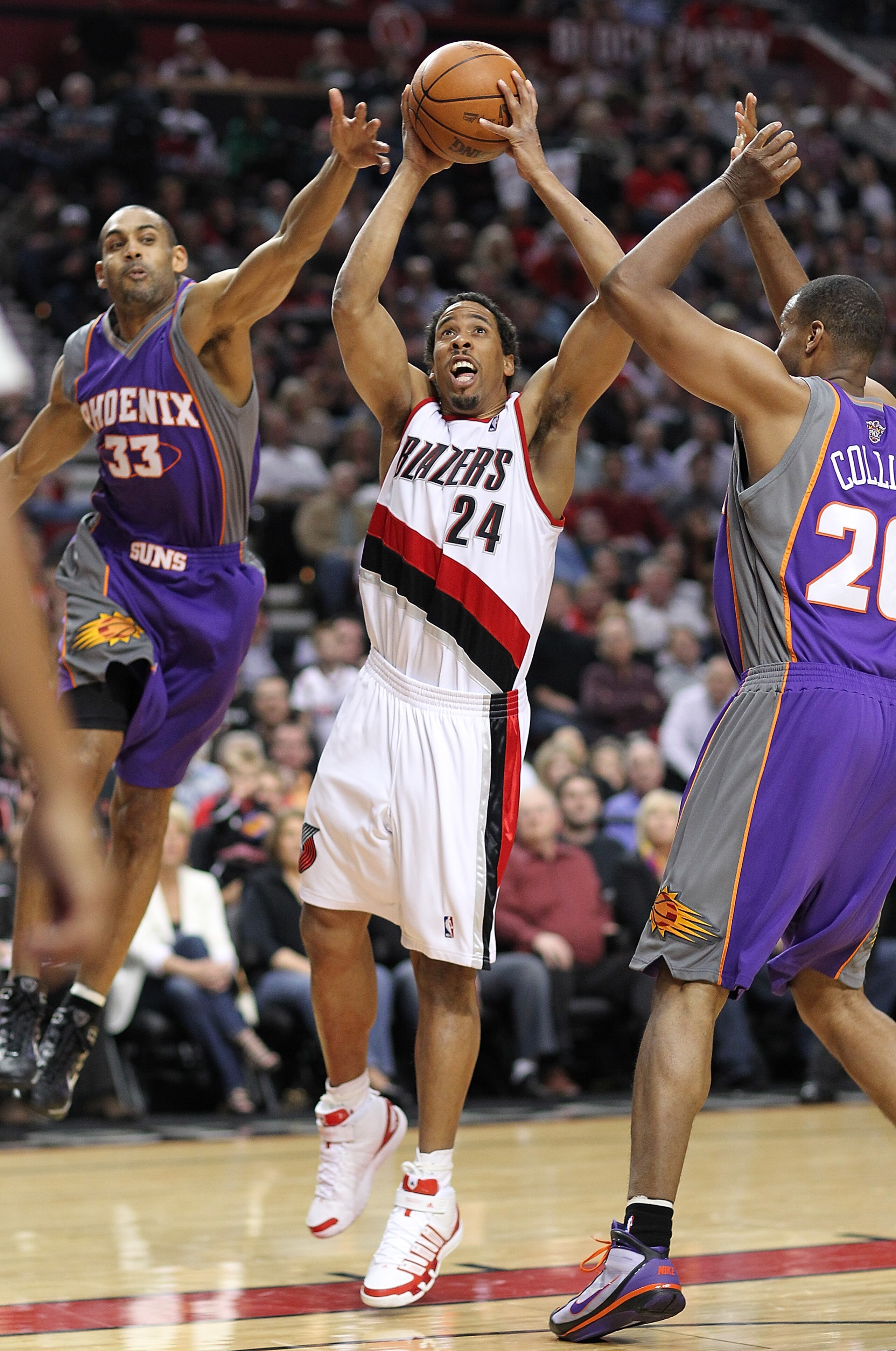 PORTLAND, OR - APRIL 29:  Andre Miller #24 of the Portland Trail Blazers rebounds against Grant Hill #33 and Jarron Collins #20 of the Phoenix Suns during Game Six of the Western Conference Quarterfinals of the NBA Playoffs on April 29, 2010 at the Rose G