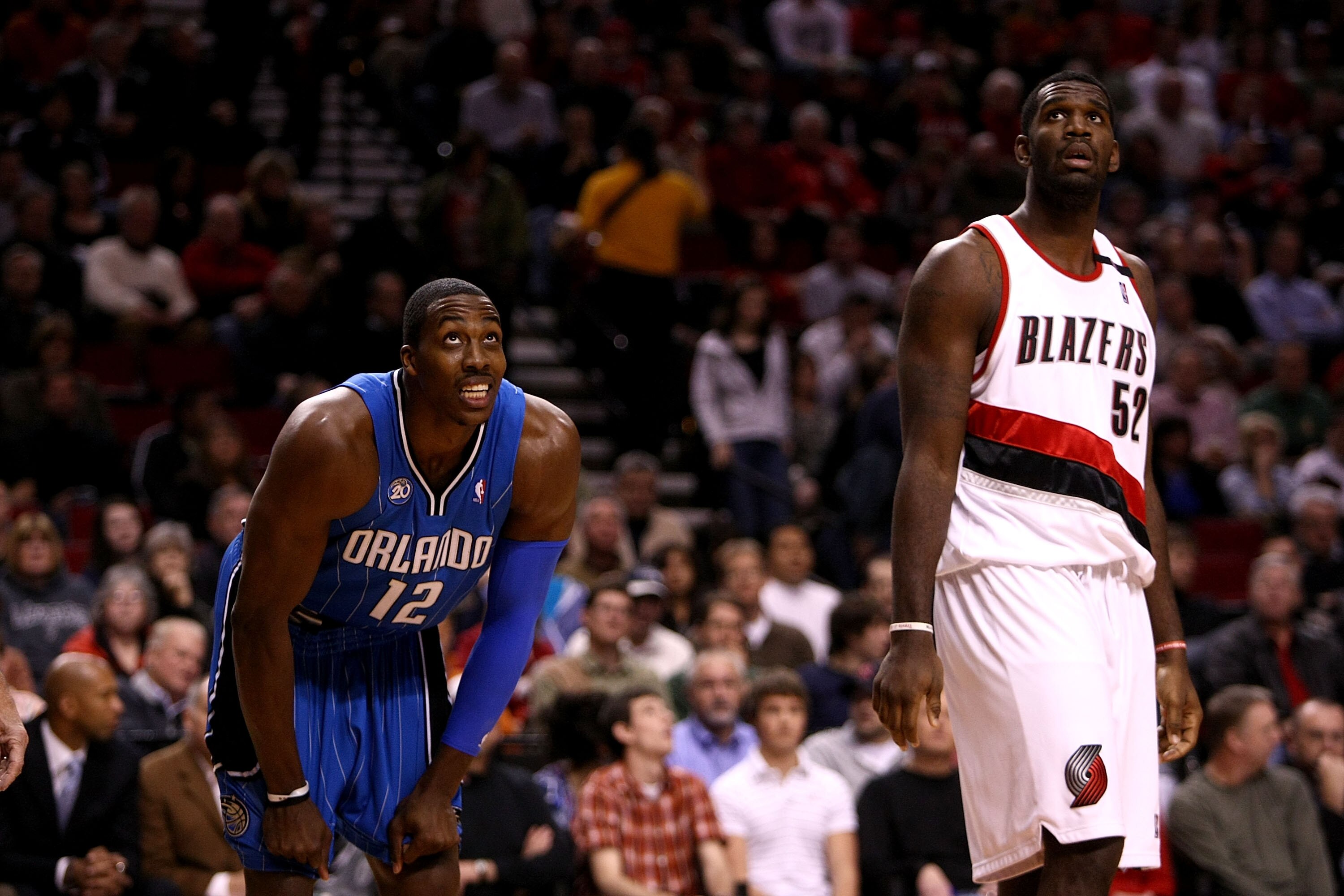 PORTLAND, OR - DECEMBER 09:  Dwight Howard #12 of the Orlando Magic watches a freethrow with Greg Oden #52 of the Portland Trail Blazers for a rebound at the Rose Garden on December 9, 2008 in Portland, Oregon.  NOTE TO USER: User expressly acknowledges a