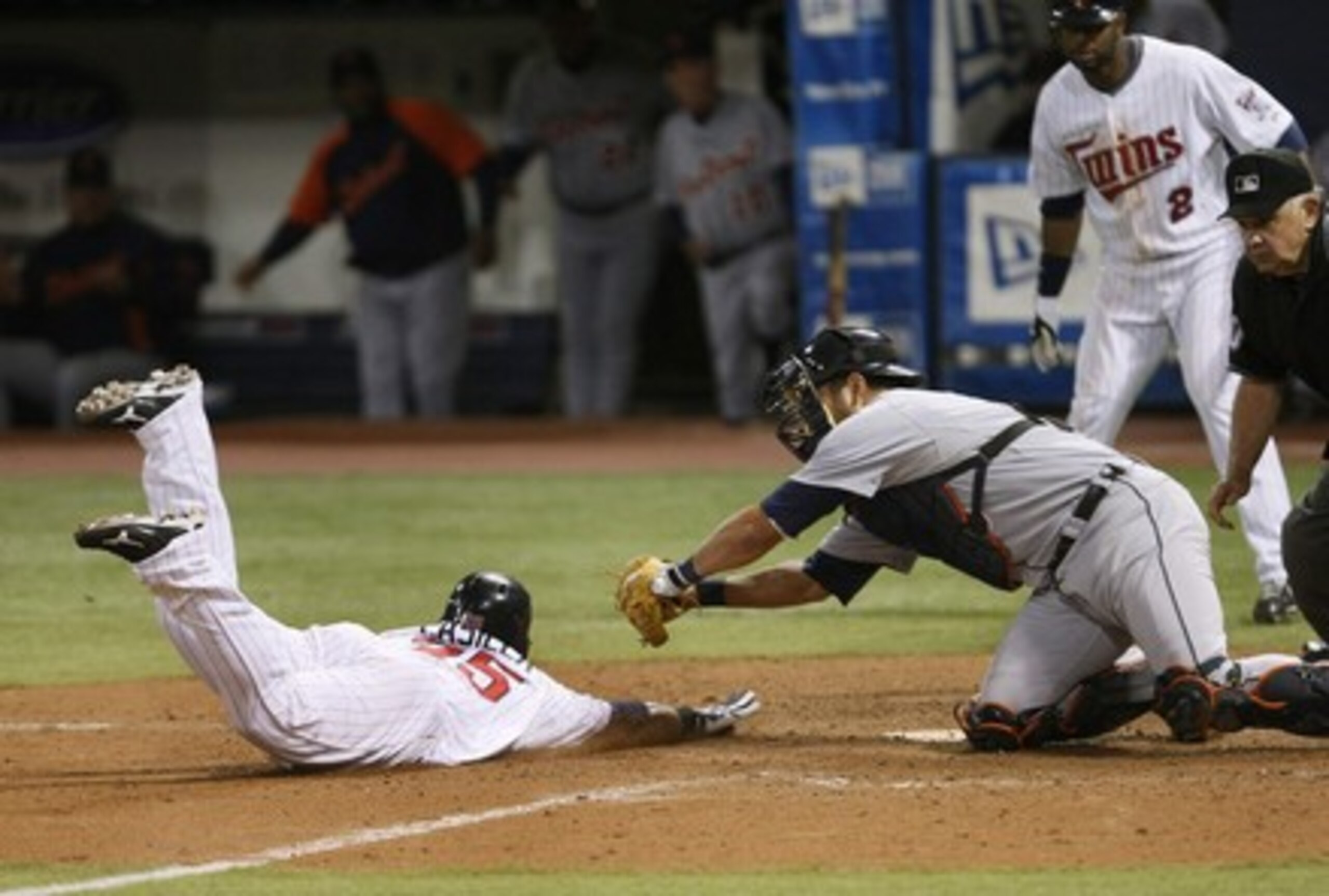 Laird attempting to tag oug a runner at home