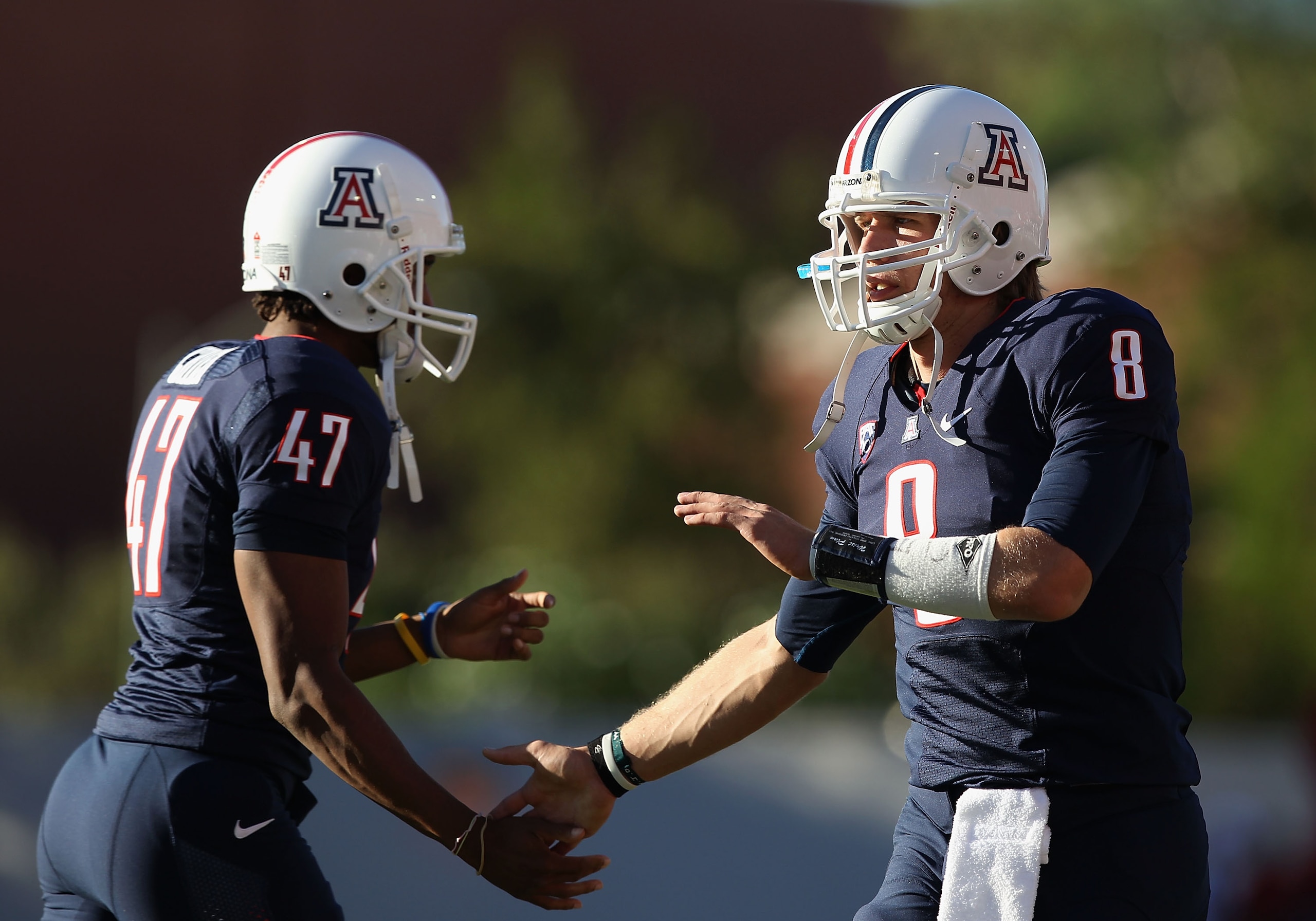 TUCSON, AZ - OCTOBER 09:  Quarterback Nick Foles #8 of the Arizona Wildcats celebrates with teammate Keenyn Crier #47 after the Wildcats scored a first quarter touchdown against the Oregon State Beavers during the college football game at Arizona Stadium