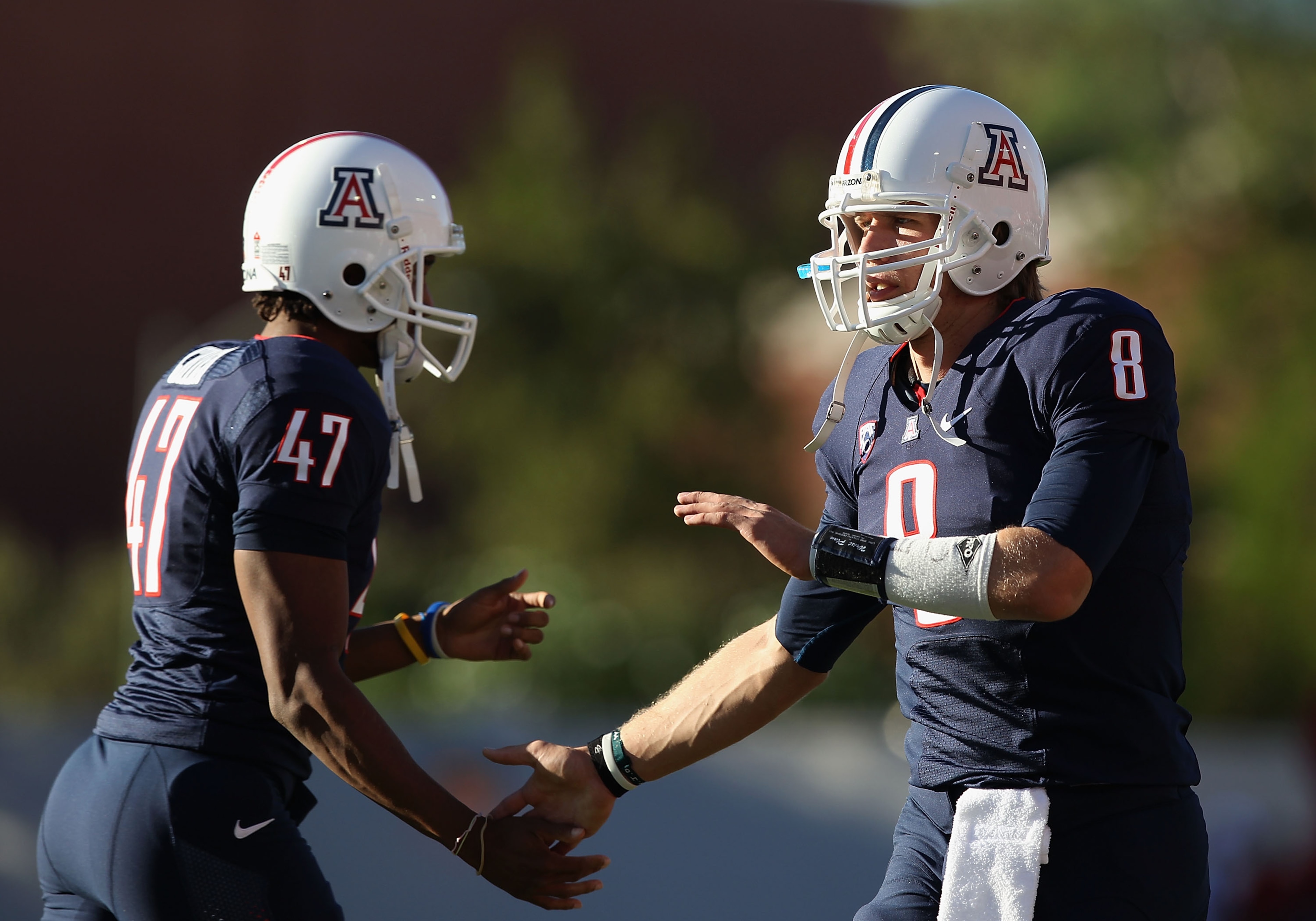TUCSON, AZ - OCTOBER 09:  Quarterback Nick Foles #8 of the Arizona Wildcats celebrates with teammate Keenyn Crier #47 after the Wildcats scored a first quarter touchdown against the Oregon State Beavers during the college football game at Arizona Stadium