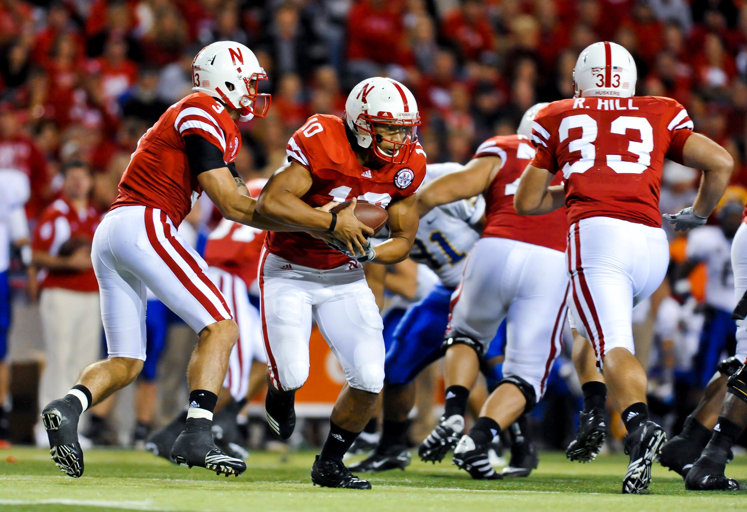 LINCOLN, NEBRASKA - SEPTEMBER 25: Nebraska Cornhuskers quarterback Taylor Martinez #3 hands the ball to running back Roy Helu Jr. #10 during second half action of their game at Memorial Stadium on September 25, 2010 in Lincoln, Nebraska. Nebraska Defeated