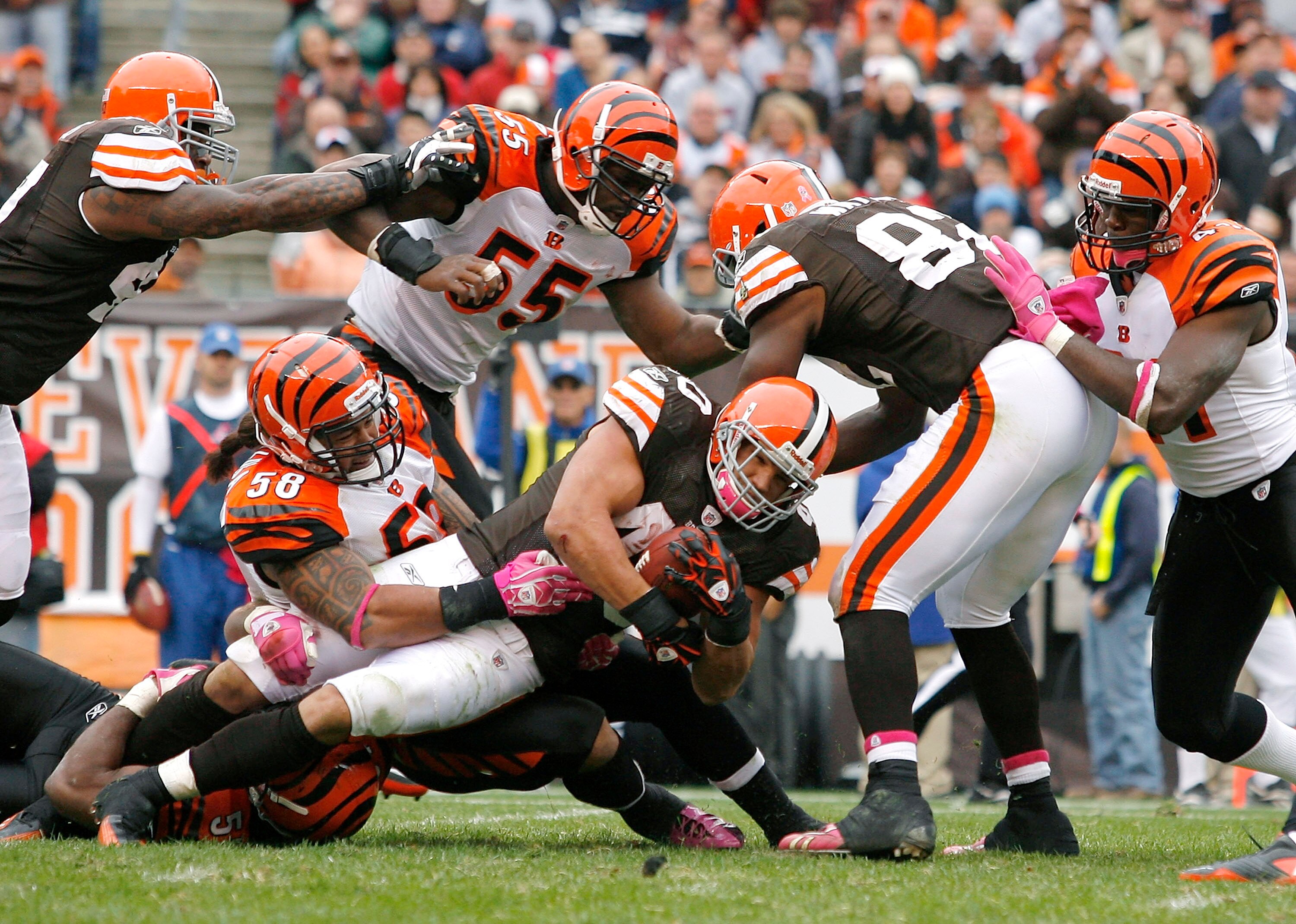 CLEVELAND - OCTOBER 03:  Running back Peyton Hillis #40 of the Cleveland Browns is tackled by defenders Keith Rivers #55 and Rey Maualuga #58 of the Cincinnati Bengals at Cleveland Browns Stadium on October 3, 2010 in Cleveland, Ohio.  (Photo by Matt Sull