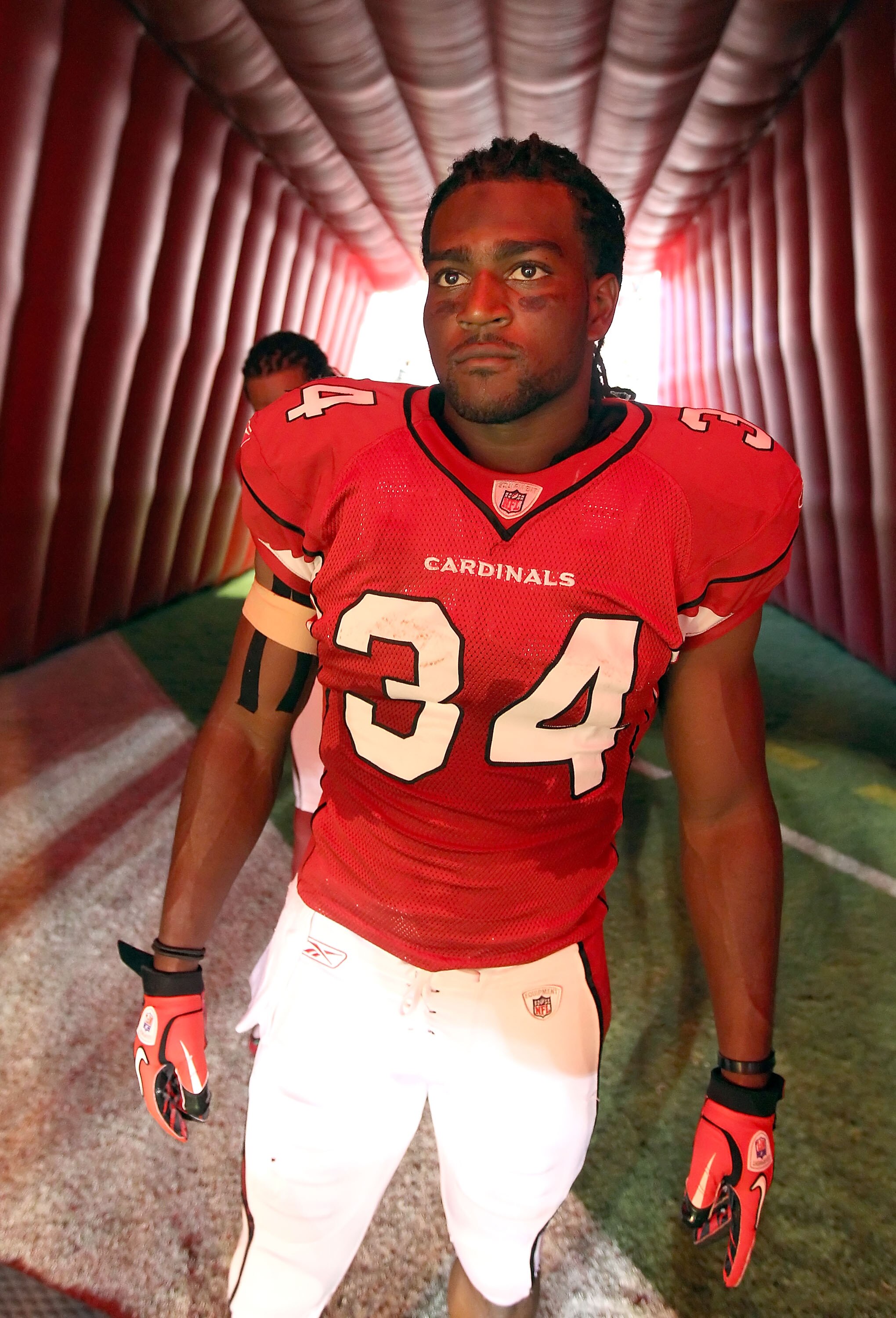 GLENDALE, AZ - SEPTEMBER 26:  Runningback Tim Hightower #34 of the Arizona Cardinals waits to be introduced before the NFL game against the Oakland Raiders at the University of Phoenix Stadium on September 26, 2010 in Glendale, Arizona.  The Cardinals def