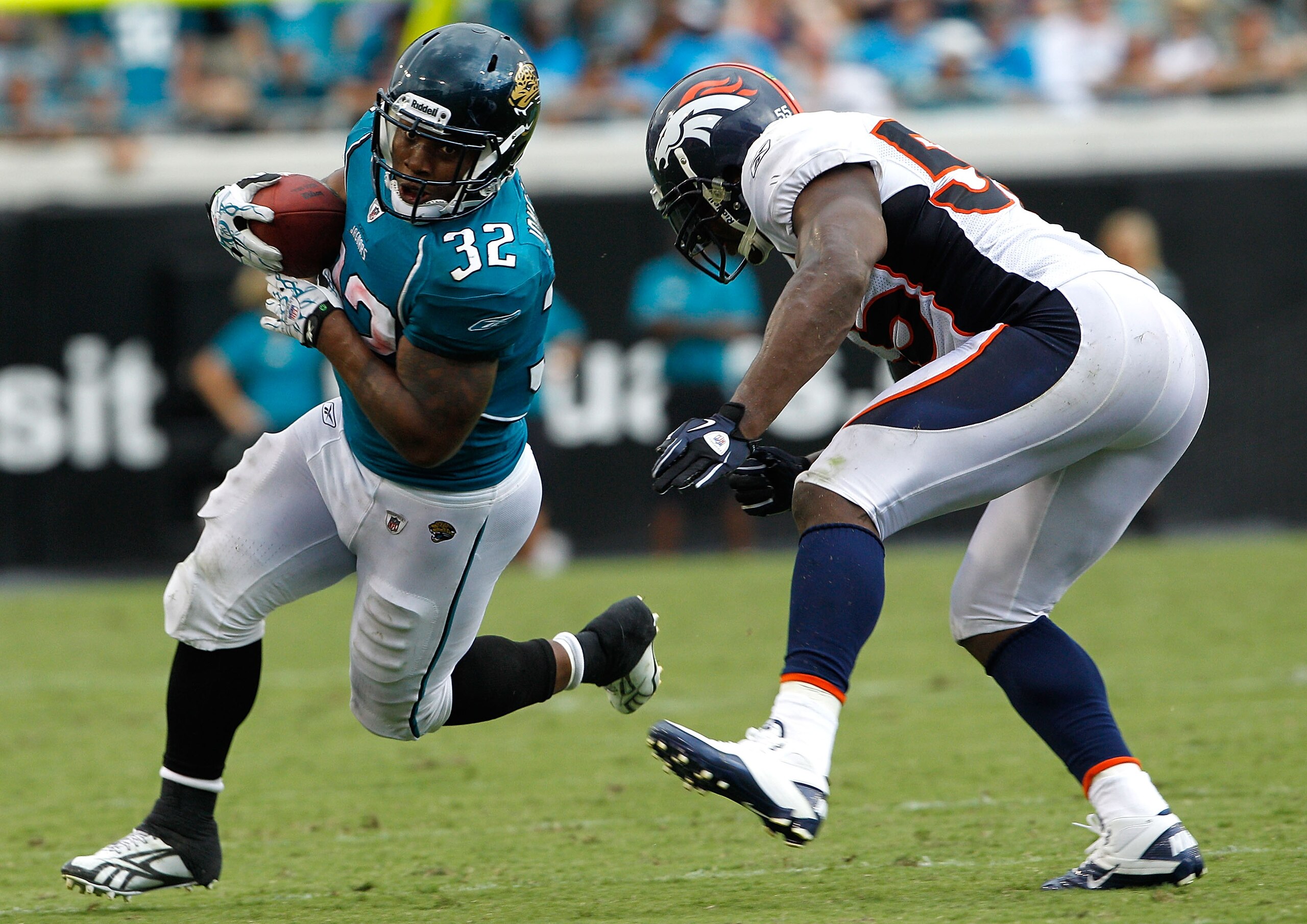 JACKSONVILLE, FL - SEPTEMBER 12:  D.J. Williams #55 of the Denver Broncos attempts to tackle Maurice Jones-Drew #32 of the Jacksonville Jaguars during the NFL season opener game at EverBank Field on September 12, 2010 in Jacksonville, Florida.  (Photo by