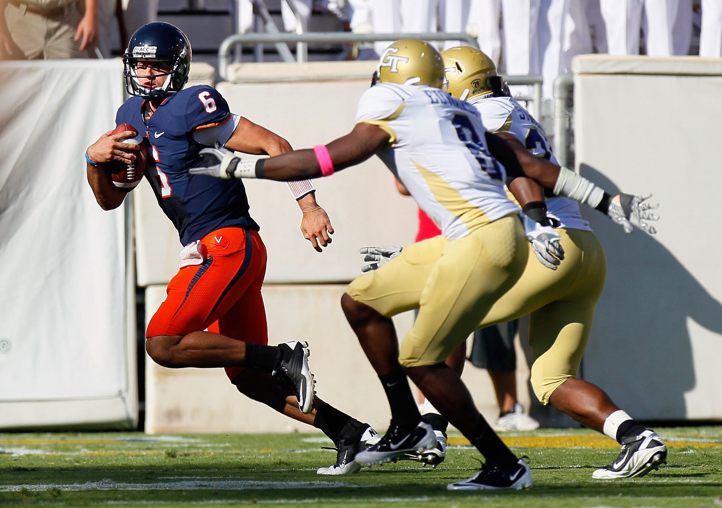 ATLANTA - OCTOBER 09:  Quarterback Marc Verica #6 of the Virginia Cavaliers is flushed out of the pocket by Mario Edwards #8 and Steven Sylvester #34 of the Georgia Tech Yellow Jackets at Bobby Dodd Stadium on October 9, 2010 in Atlanta, Georgia.  (Photo
