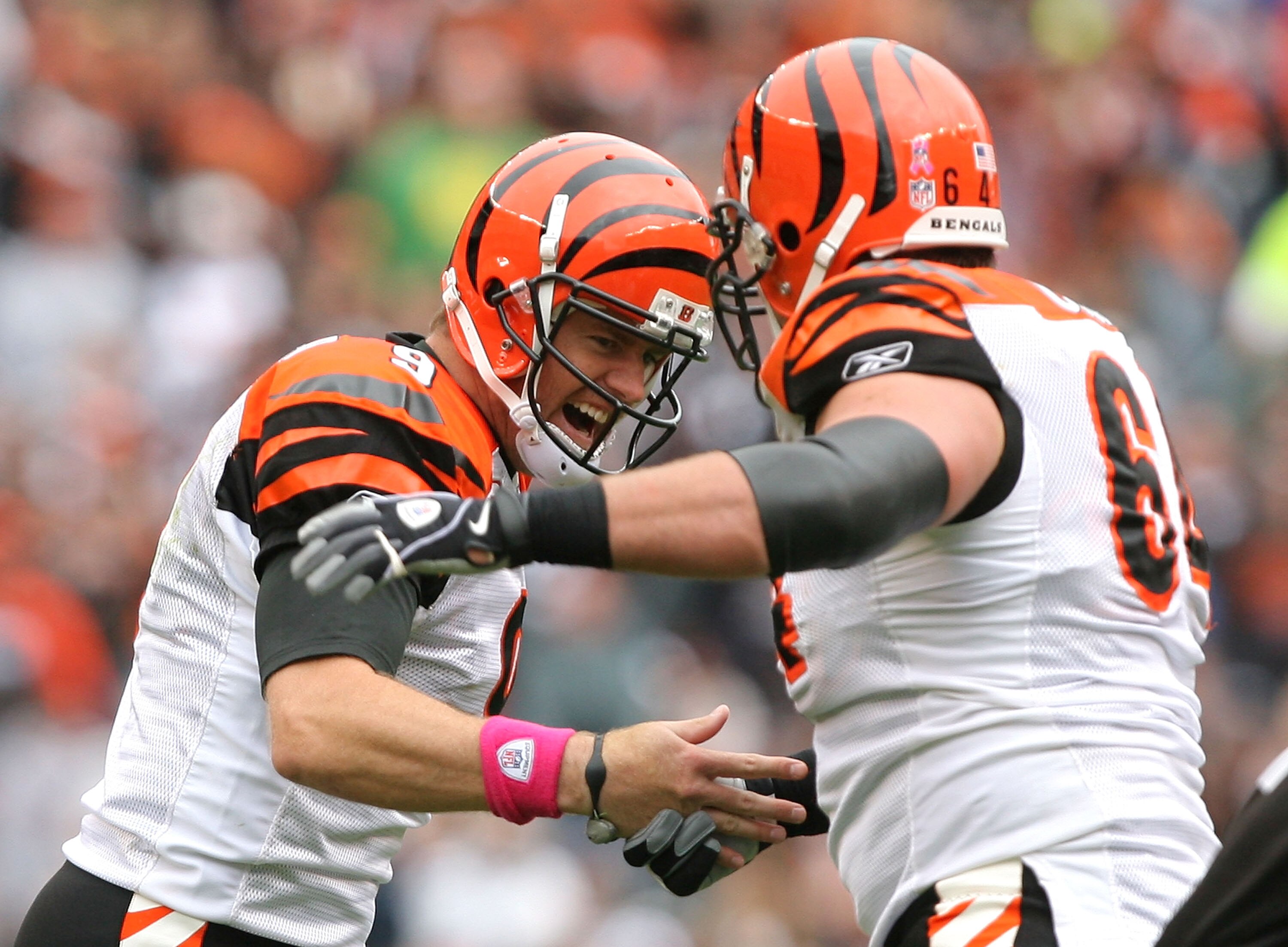 CLEVELAND - OCTOBER 03:  Quarterback Carson Palmer #9 and Kyle Cook #64 of the Cincinnati Bengals celebrates after throwing a touchdown pass against the Cleveland Browns during the first half at Cleveland Browns Stadium on October 3, 2010 in Cleveland, Oh