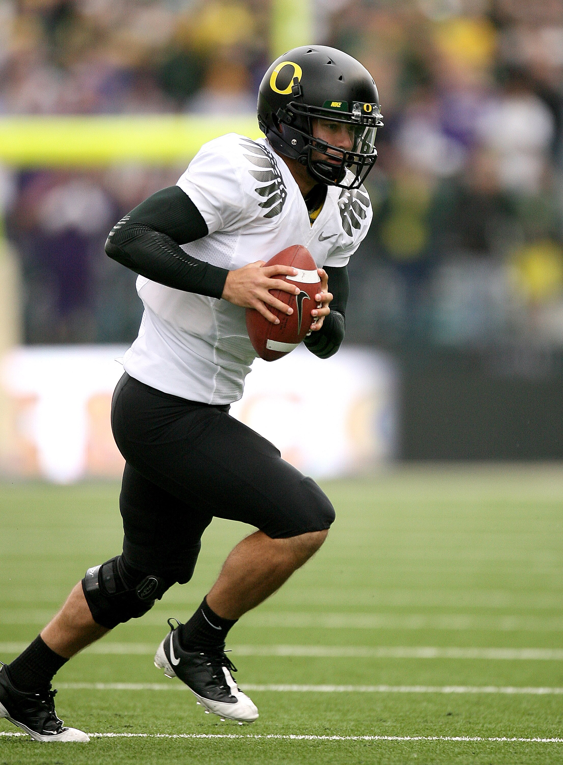 SEATTLE - OCTOBER 24:  Holder Nate Costa #7 of the Oregon Ducks advances the ball on a fake field goal against the Washington Huskies on October 24, 2009 at Husky Stadium in Seattle, Washington. The Ducks defeated the Huskies 43-19. (Photo by Otto Greule