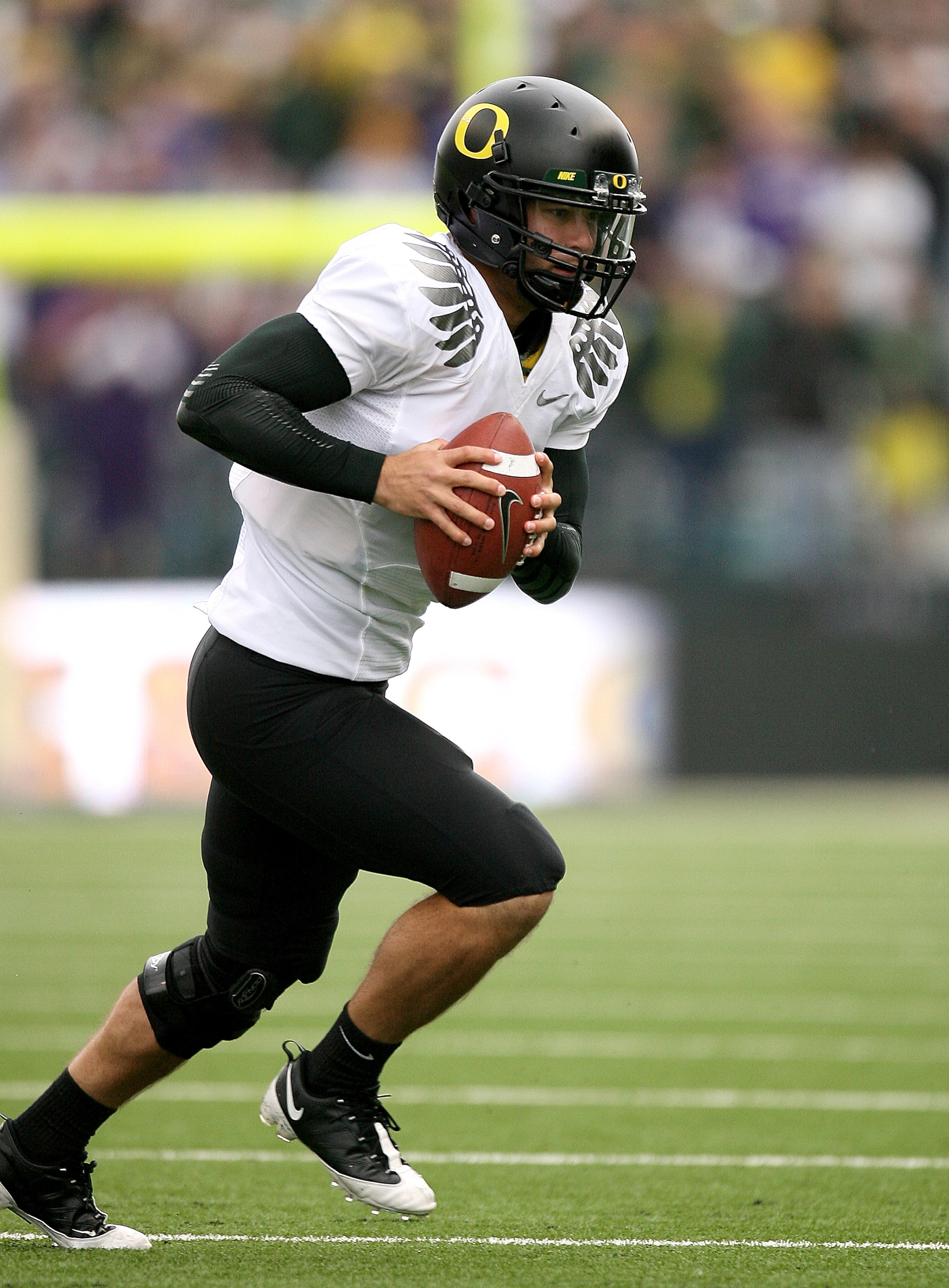 SEATTLE - OCTOBER 24:  Holder Nate Costa #7 of the Oregon Ducks advances the ball on a fake field goal against the Washington Huskies on October 24, 2009 at Husky Stadium in Seattle, Washington. The Ducks defeated the Huskies 43-19. (Photo by Otto Greule