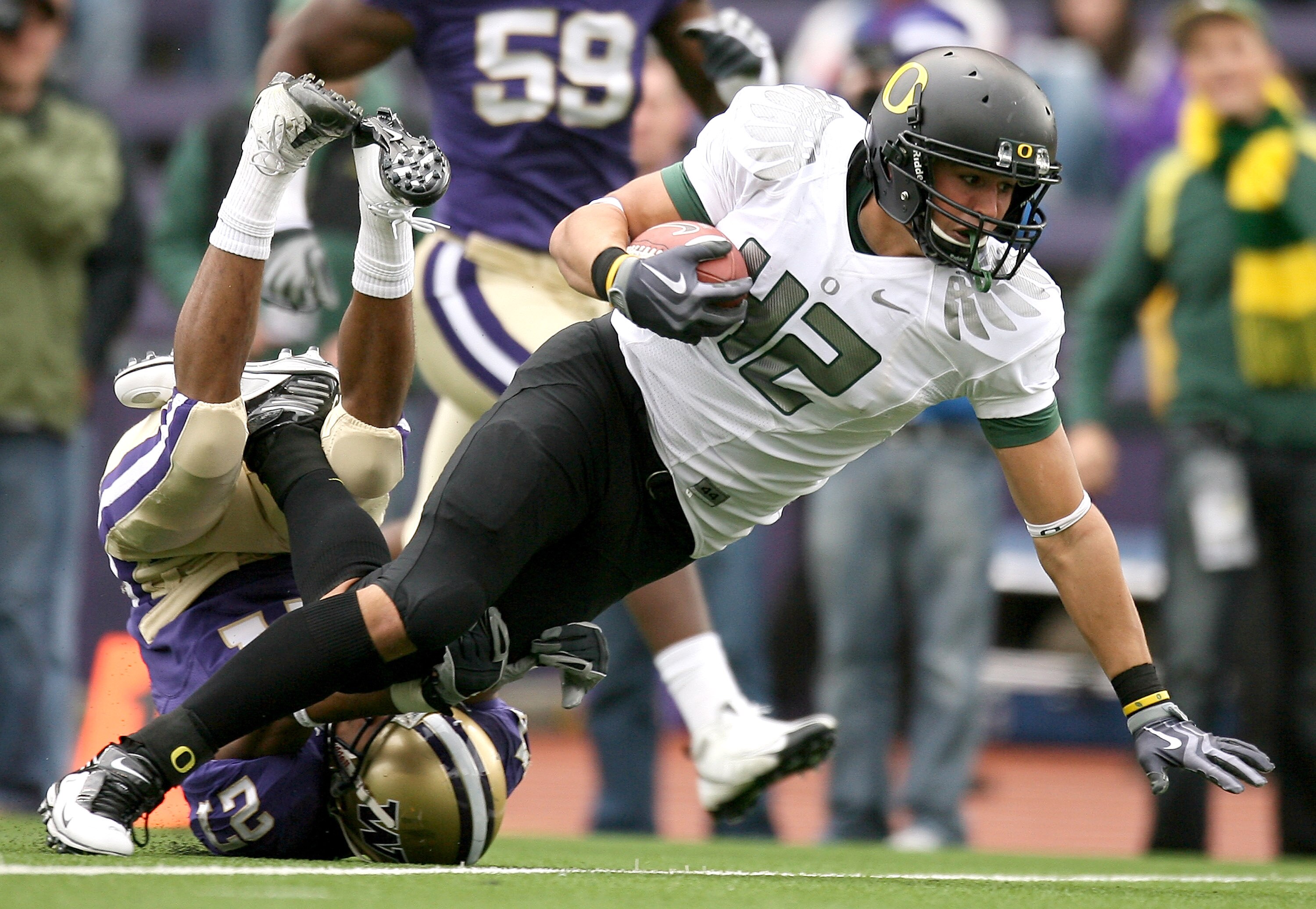 SEATTLE - OCTOBER 24:  Tight end David Paulson #42 of the Oregon Ducks rushes against Adam Long #27 of the Washington Huskies on October 24, 2009 at Husky Stadium in Seattle, Washington. The Ducks defeated the Huskies 43-19. (Photo by Otto Greule Jr/Getty