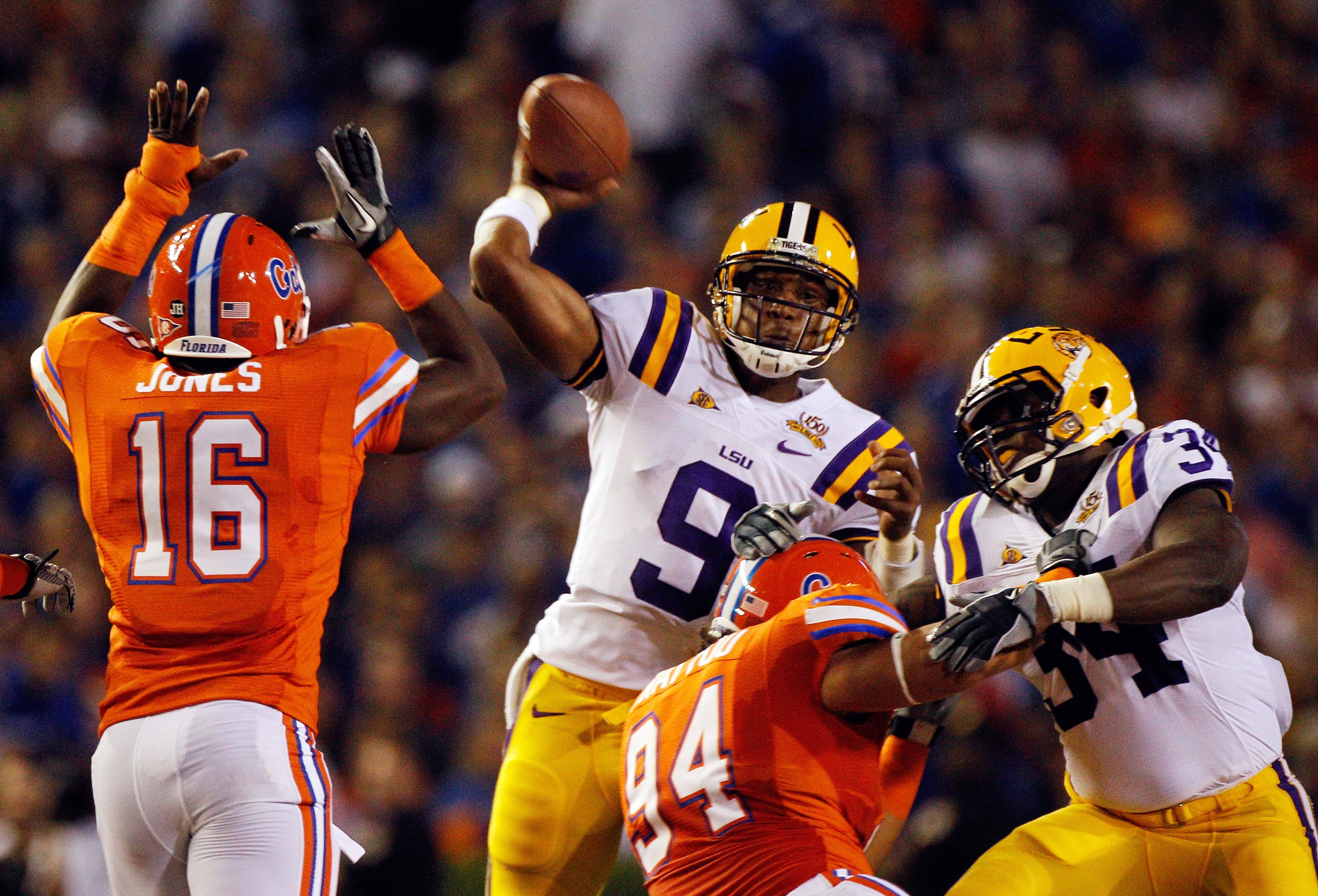 GAINESVILLE, FL - OCTOBER 09:  Quarterback Jordan Jefferson #9 of the Louisiana State University Tigers attempts a pass over A.J. Jones #16 of the Florida Gators during the game at Ben Hill Griffin Stadium on October 9, 2010 in Gainesville, Florida.  (Pho