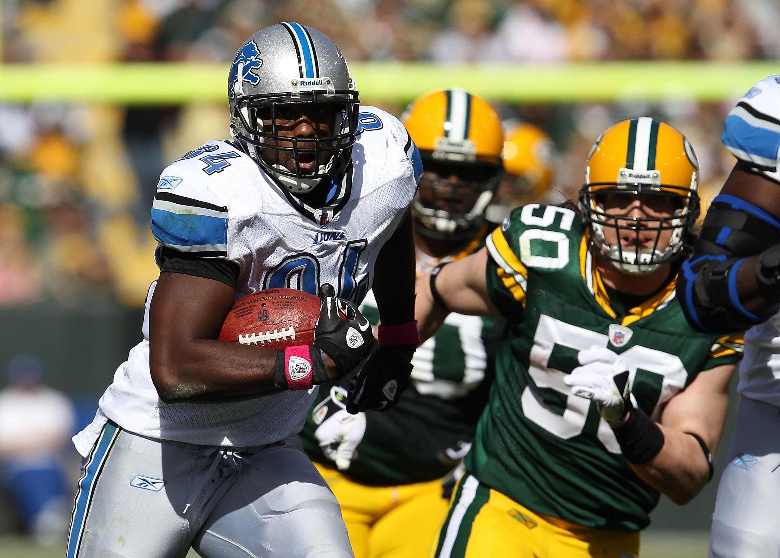 GREEN BAY, WI - OCTOBER 03: Brandon Pettigrew #84 of the Detroit Lions runs after a catch pursed by A.J. Hawk #50 and B.J. Raji #90 of the Green Bay Packers at Lambeau Field on October 3, 2010 in Green Bay, Wisconsin. The Packers defeated the Lions 28-26.