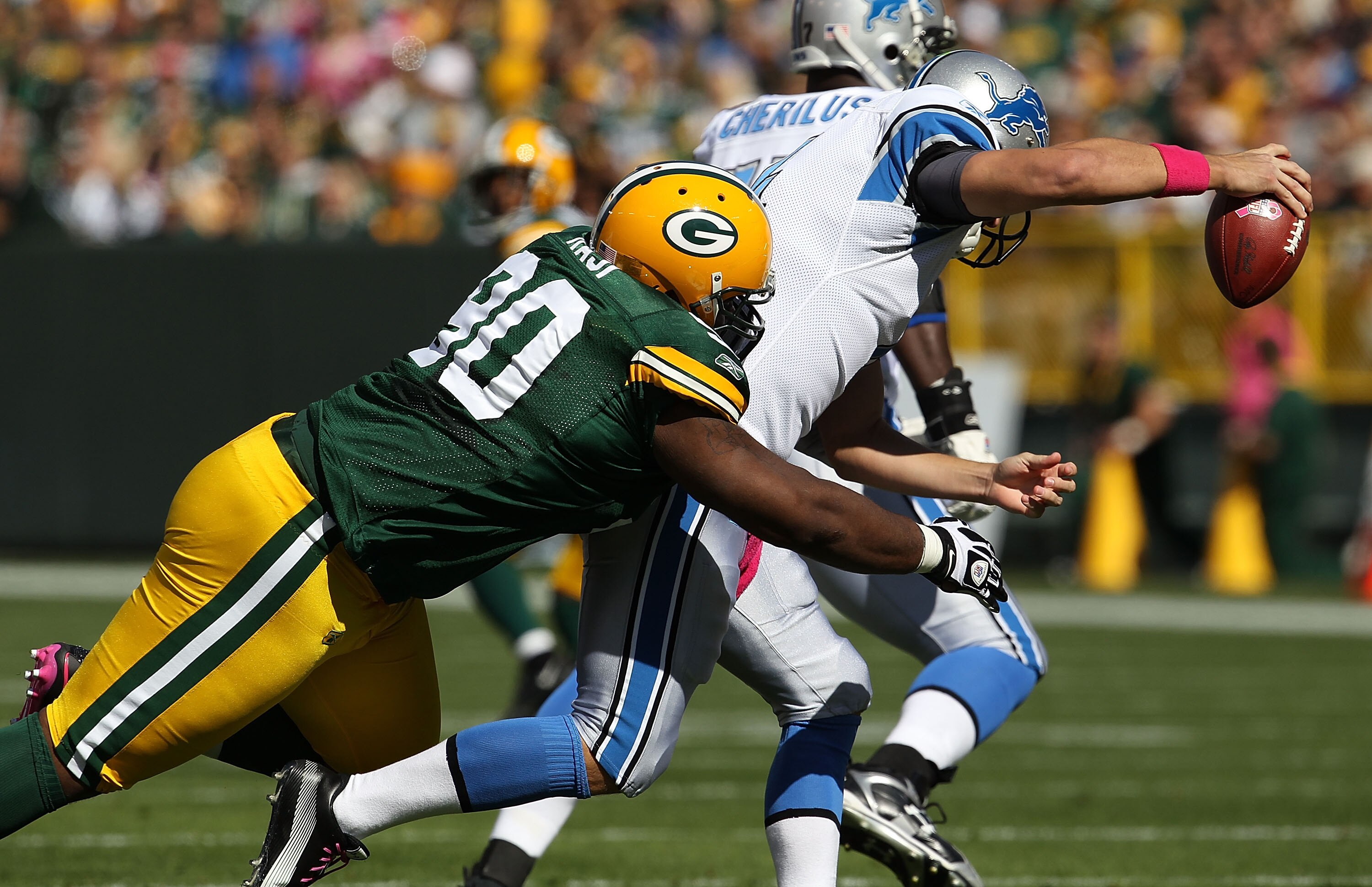 GREEN BAY, WI - OCTOBER 03: B.J. Raji #90 of the Green Bay Packers sacks Shaun Hill #14 of the Detroit Lions at Lambeau Field on October 3, 2010 in Green Bay, Wisconsin. The Packers defeated the Lions 28-26. (Photo by Jonathan Daniel/Getty Images)