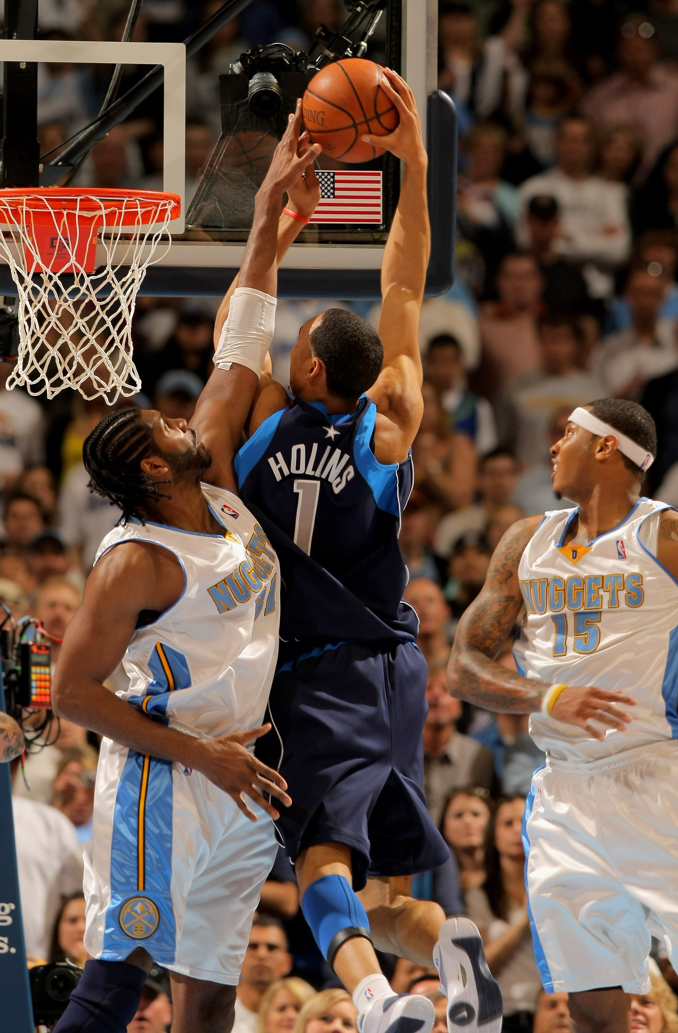 DENVER - MAY 03:  Nene #31 of the Denver Nuggets defends on a shot by Ryan Hollins #1 of the Dallas Mavericks in Game One of the Western Conference Semifinals during the 2009 NBA Playoffs at Pepsi Center on May 3, 2009 in Denver, Colorado. The Nuggets def