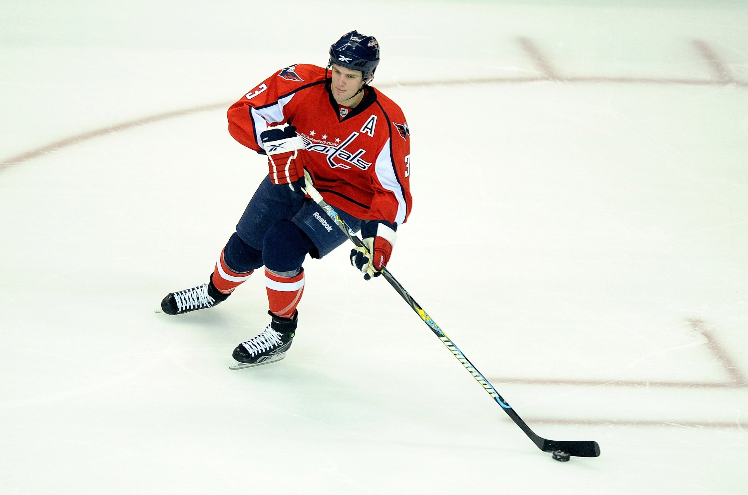 WASHINGTON - APRIL 15:  Tom Poti #3 of the Washington Capitals handles the puck against the Montreal Canadiens in Game One of the Eastern Conference Quarterfinals during the 2010 NHL Stanley Cup Playoffs at Verizon Center on April 15, 2010 in Washington,