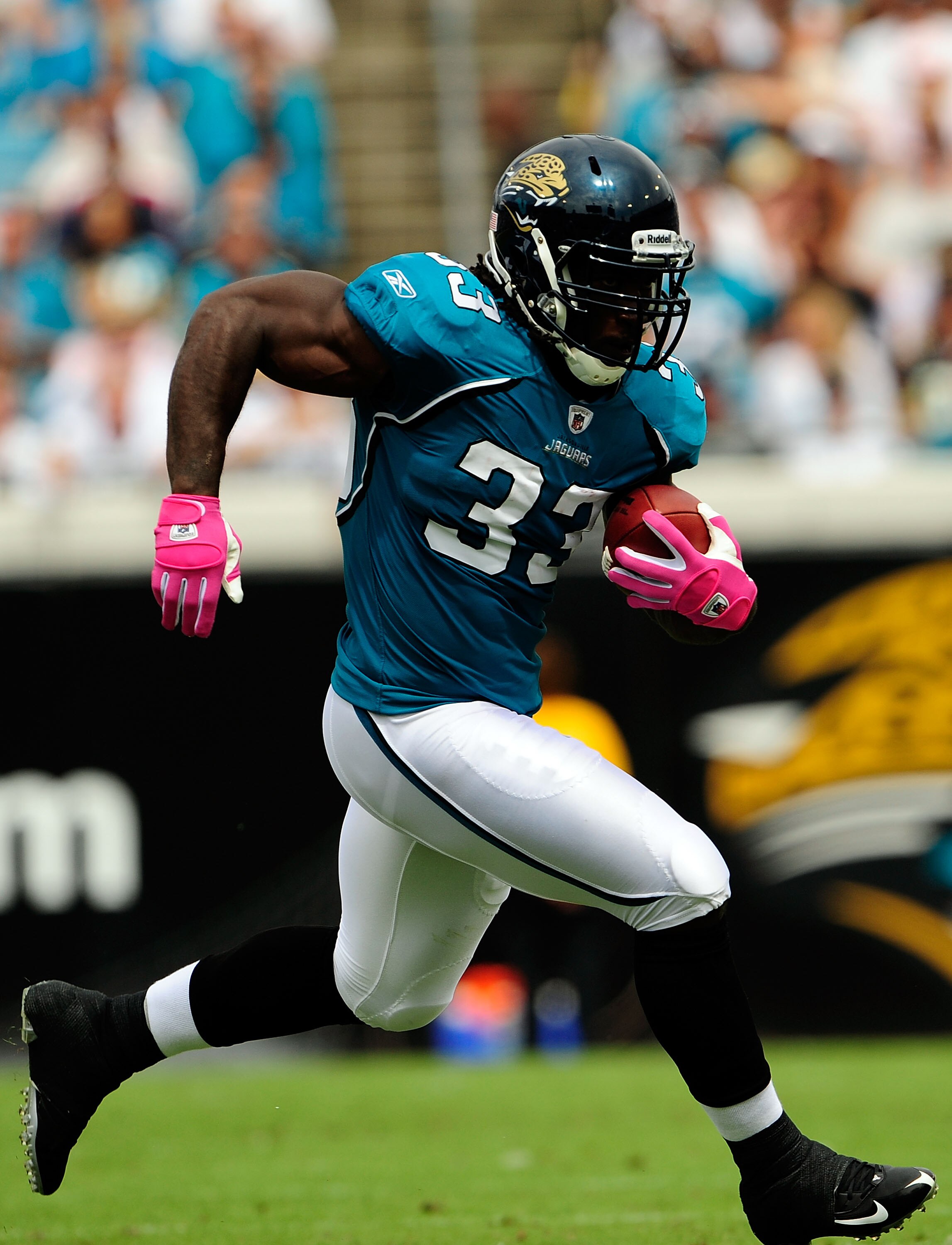 JACKSONVILLE, FL - OCTOBER 04:  Greg Jones #33 of the Jacksonville Jaguars runs during the game against the Tennessee Titans at Jacksonville Municipal Stadium on October 4, 2009 in Jacksonville, Florida. Many players and officials in the NFL wore pink as