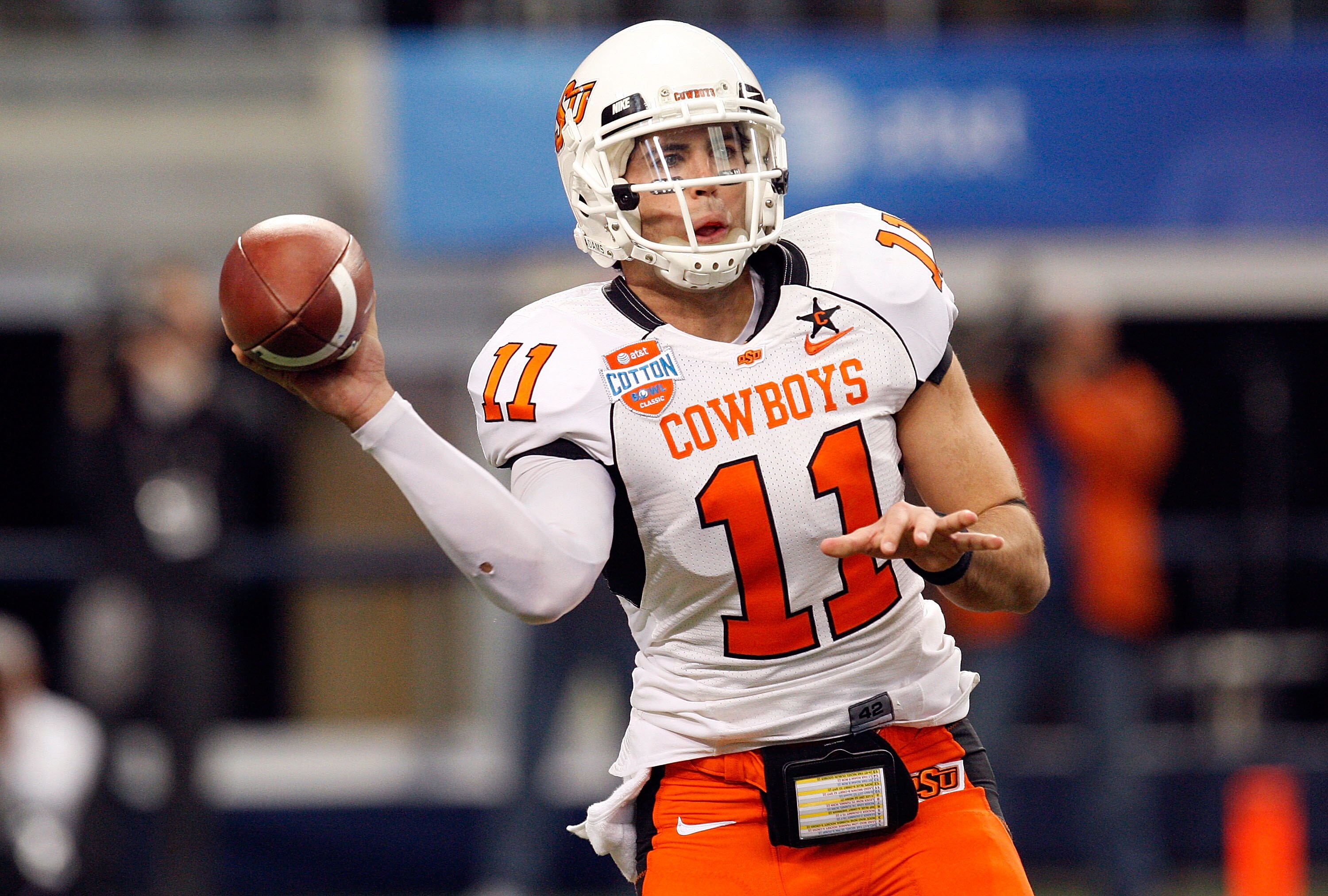 ARLINGTON, TX - JANUARY 02:  Quarterback Zac Robinson #11 of the Oklahoma State Cowboys drops back to pass against the Mississippi Rebels during the AT&T Cotton Bowl on January 2, 2010 at Cowboys Stadium in Arlington, Texas.  (Photo by Ronald Martinez/Get