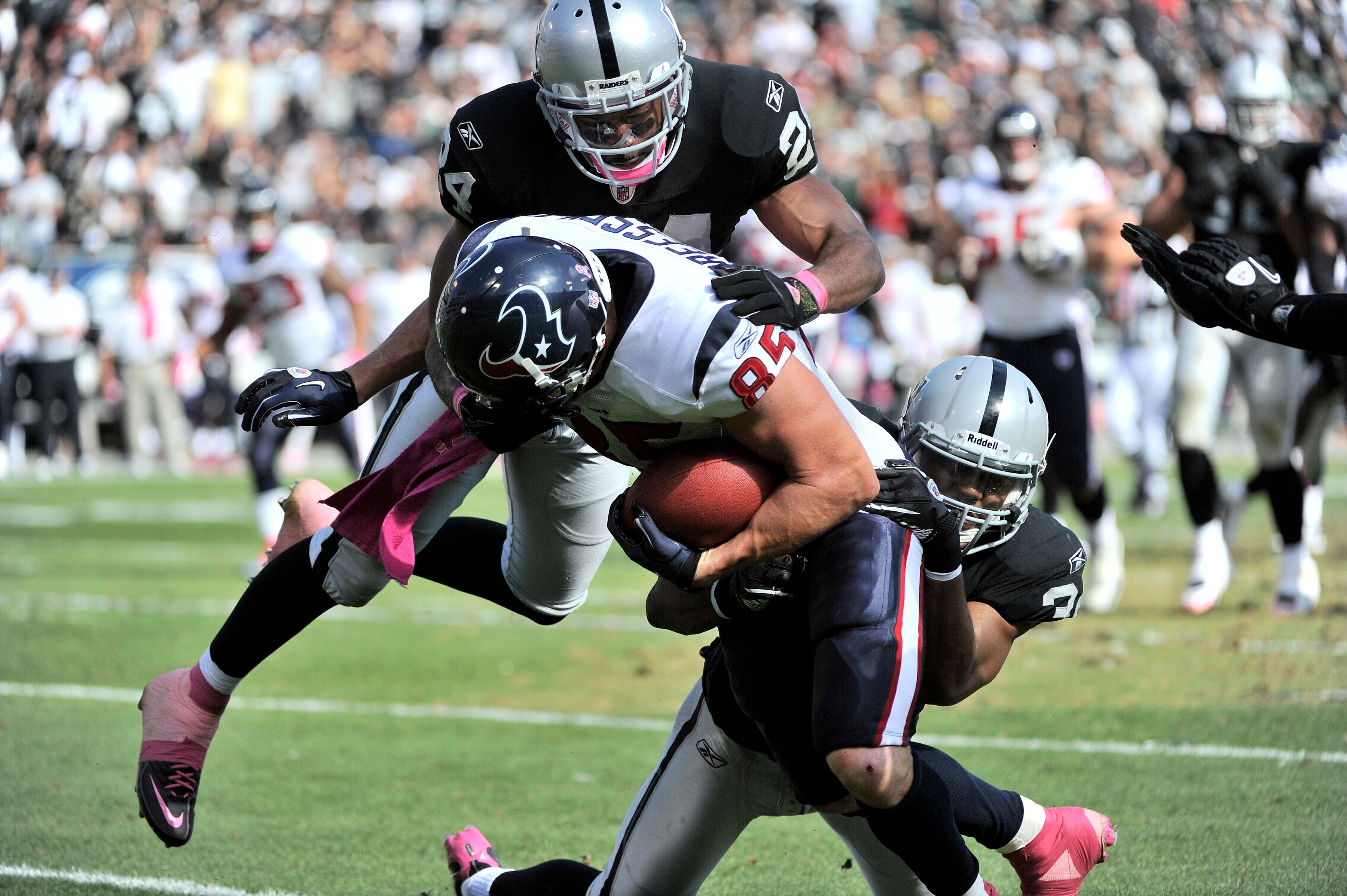 OAKLAND, CA - OCTOBER 3:  Tight end Joel Dreesen #85 of the Houston Texans is brought down by safety Michael Huff #24 of the Oakland Raiders during an NFL football game October 3, 2010 at The Oakland-Alameda County Coliseum in Oakland, California. The Tex