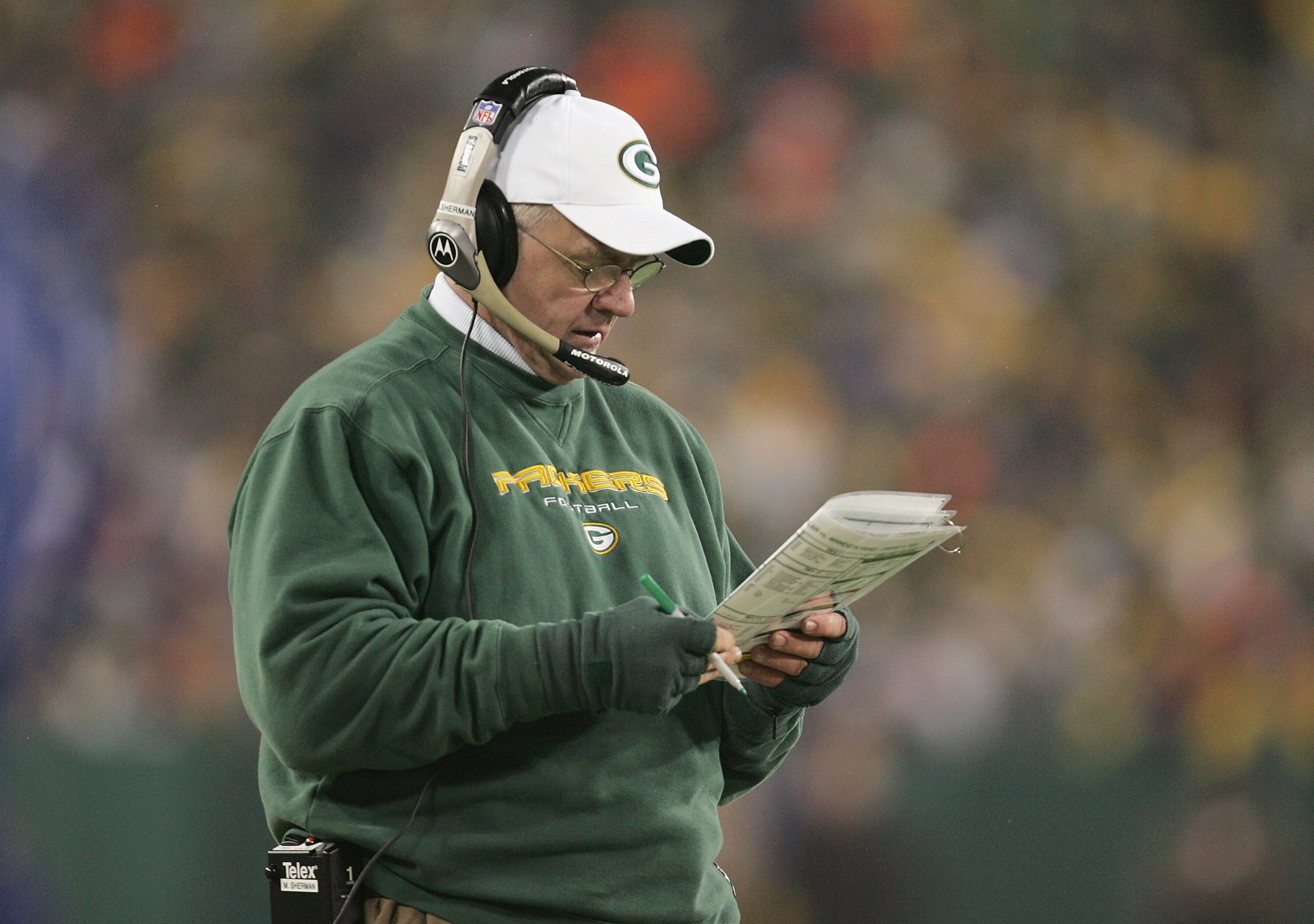 GREEN BAY, WI - JANUARY 9:  Head coach Mike Sherman of the Green Bay Packers checks his notes on the sidelines against the Minnesota Vikings in the NFC wild-card game at Lambeau Field on January 9, 2005 in Green Bay, Wisconsin. The Vikings defeated the Pa