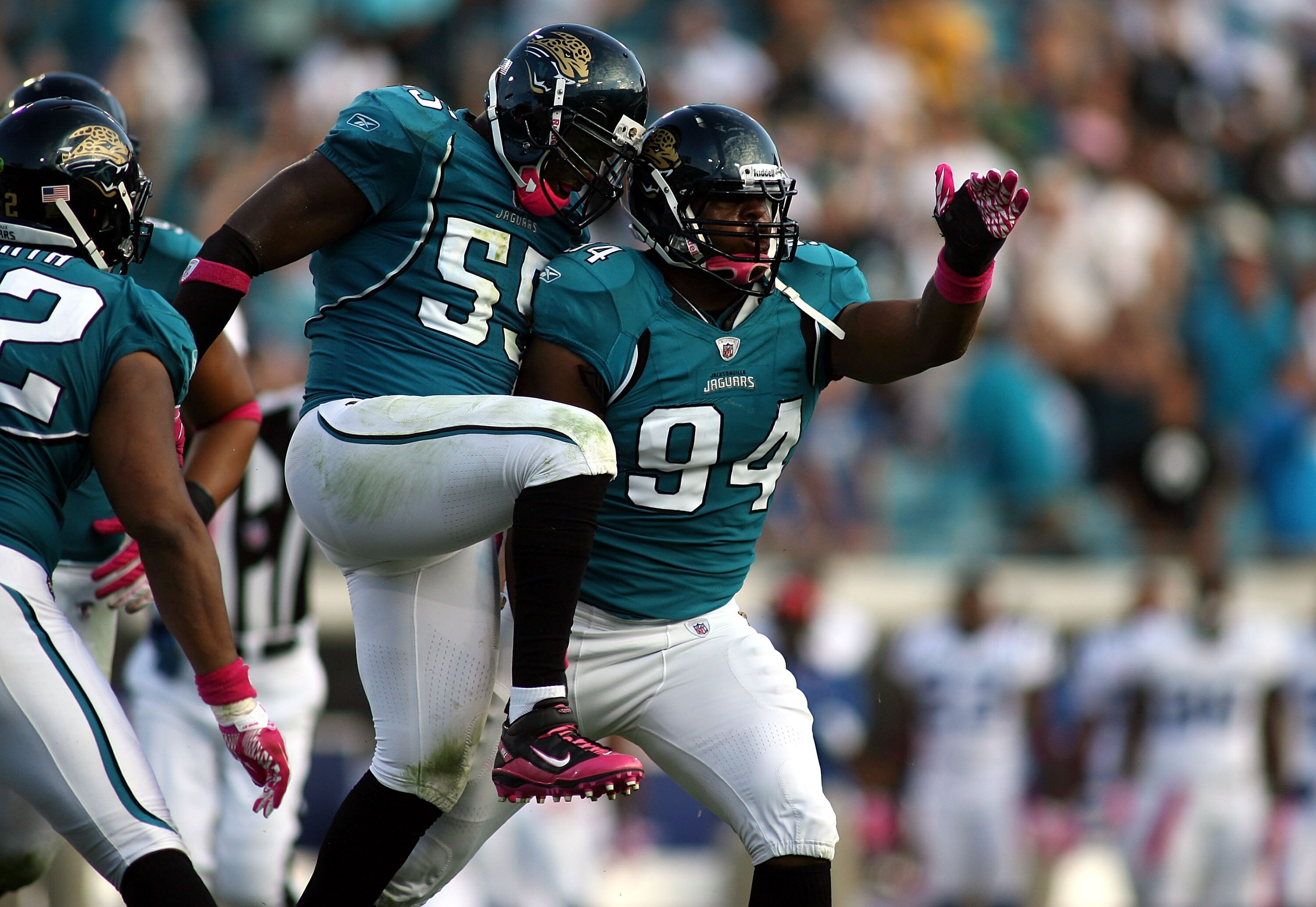 JACKSONVILLE, FL - OCTOBER 03:  Lineman Jeremy Mincey #94 of the Jacksonville Jaguars celebrates with Kirk Morreson after sacking Quarterback Peyton Manning #18 of the Indianapolis Colts at EverBank Field on October 3, 2010 in Jacksonville, Florida.  (Pho