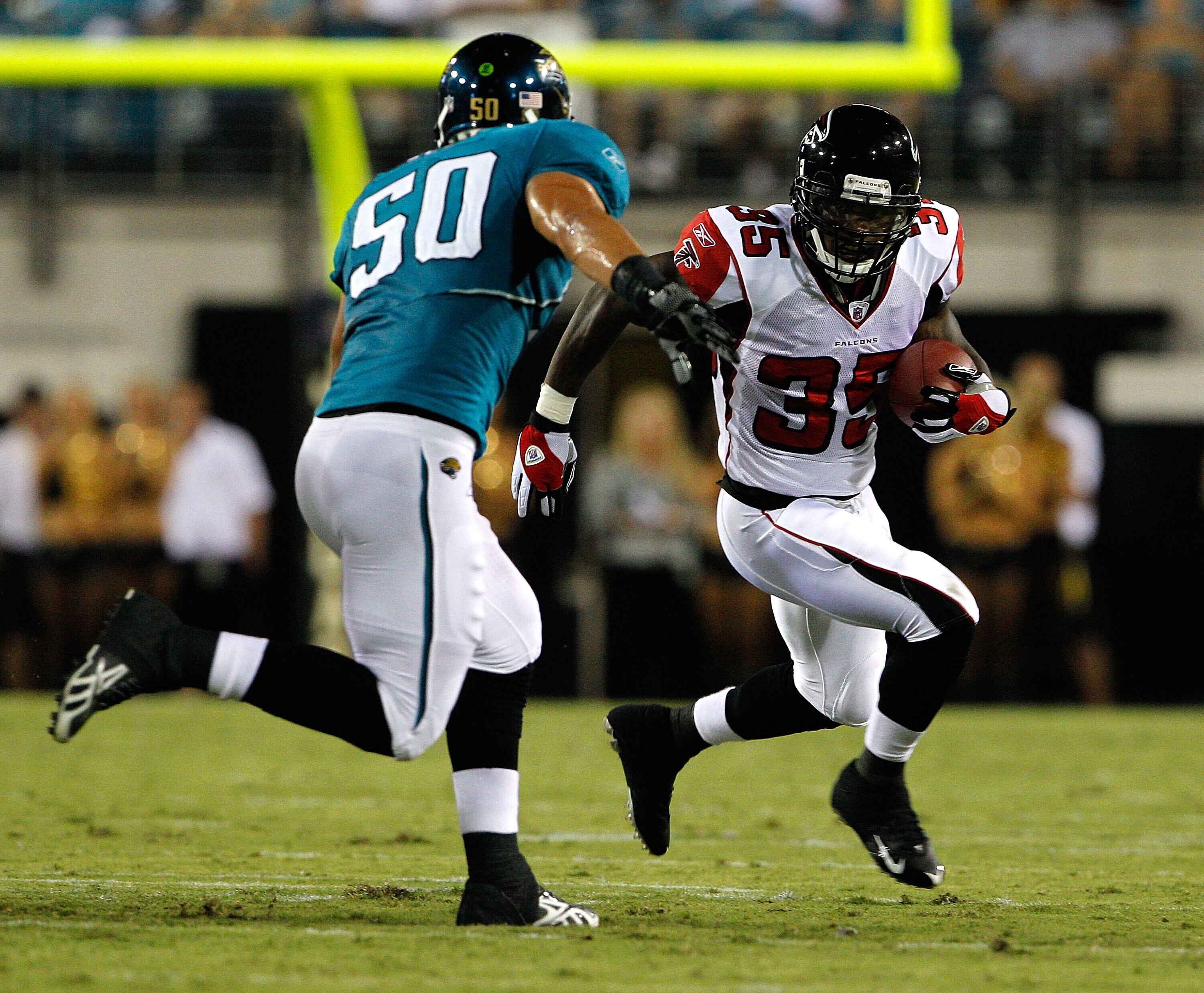 JACKSONVILLE, FL - SEPTEMBER 02:  Russell Allen #50 of the Jacksonville Jaguars attempts to tackle Antone Smith #35 of the Atlanta Falcons during a preseason game at EverBank Field on September 2, 2010 in Jacksonville, Florida.  (Photo by Sam Greenwood/Ge