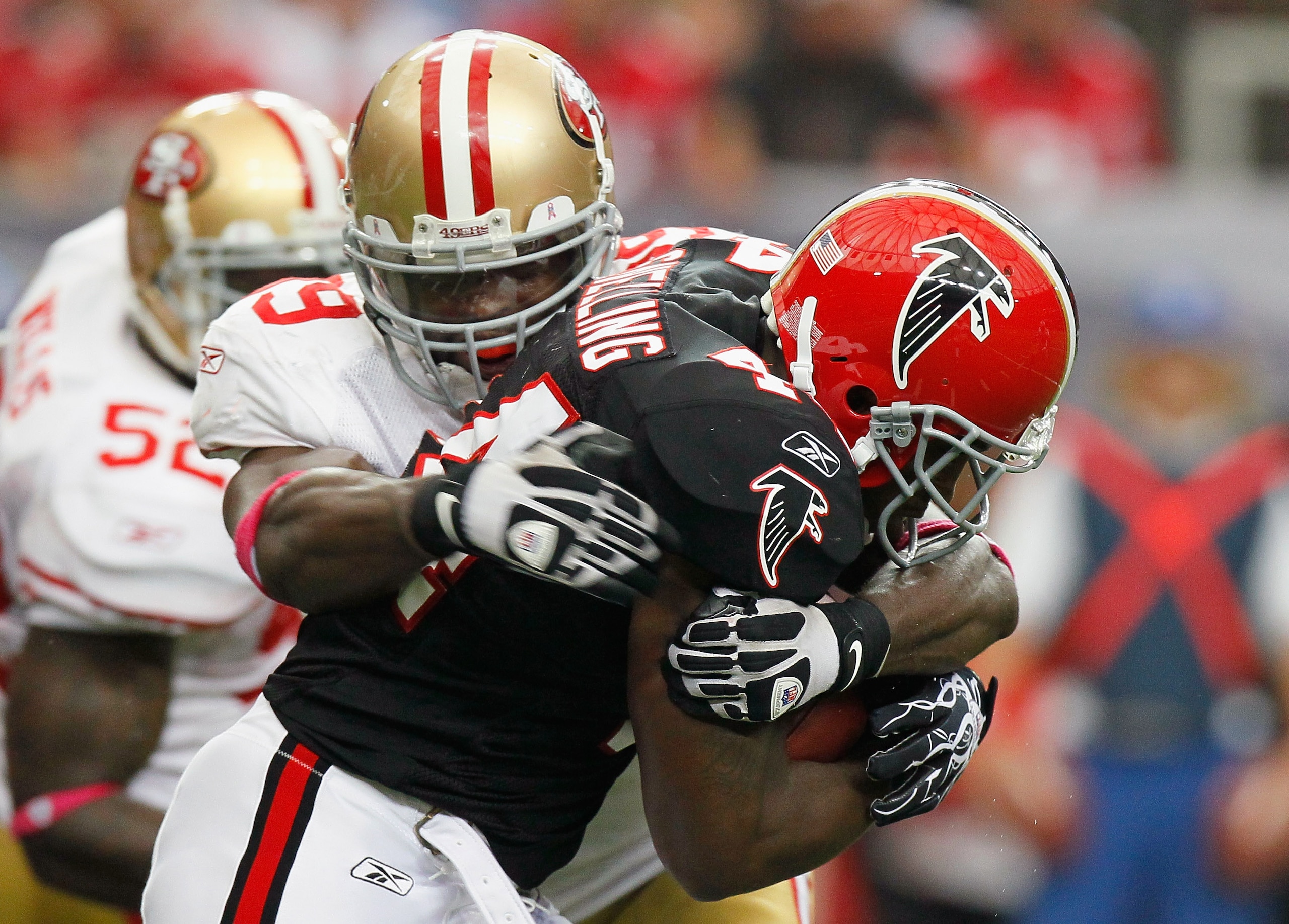 ATLANTA - OCTOBER 03:  Jason Snelling #44 of the Atlanta Falcons is tackled by Manny Lawson #99 of the San Francisco 49ers at Georgia Dome on October 3, 2010 in Atlanta, Georgia.  (Photo by Kevin C. Cox/Getty Images)