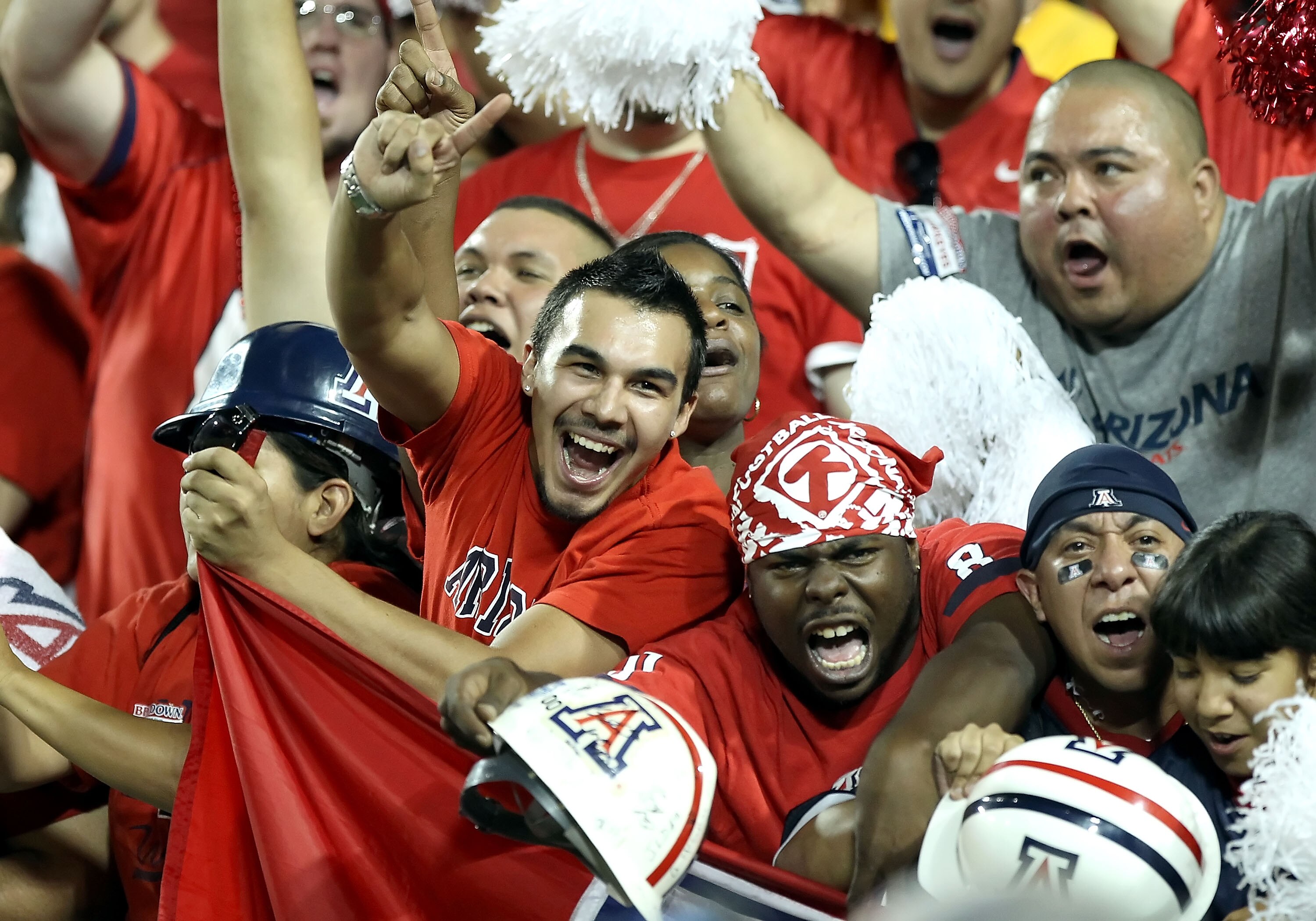 TUCSON, AZ - SEPTEMBER 18:  Fans of the Arizona Wildcats cheer during the college football game against the Iowa Hawkeyes at Arizona Stadium on September 18, 2010 in Tucson, Arizona.  (Photo by Christian Petersen/Getty Images)