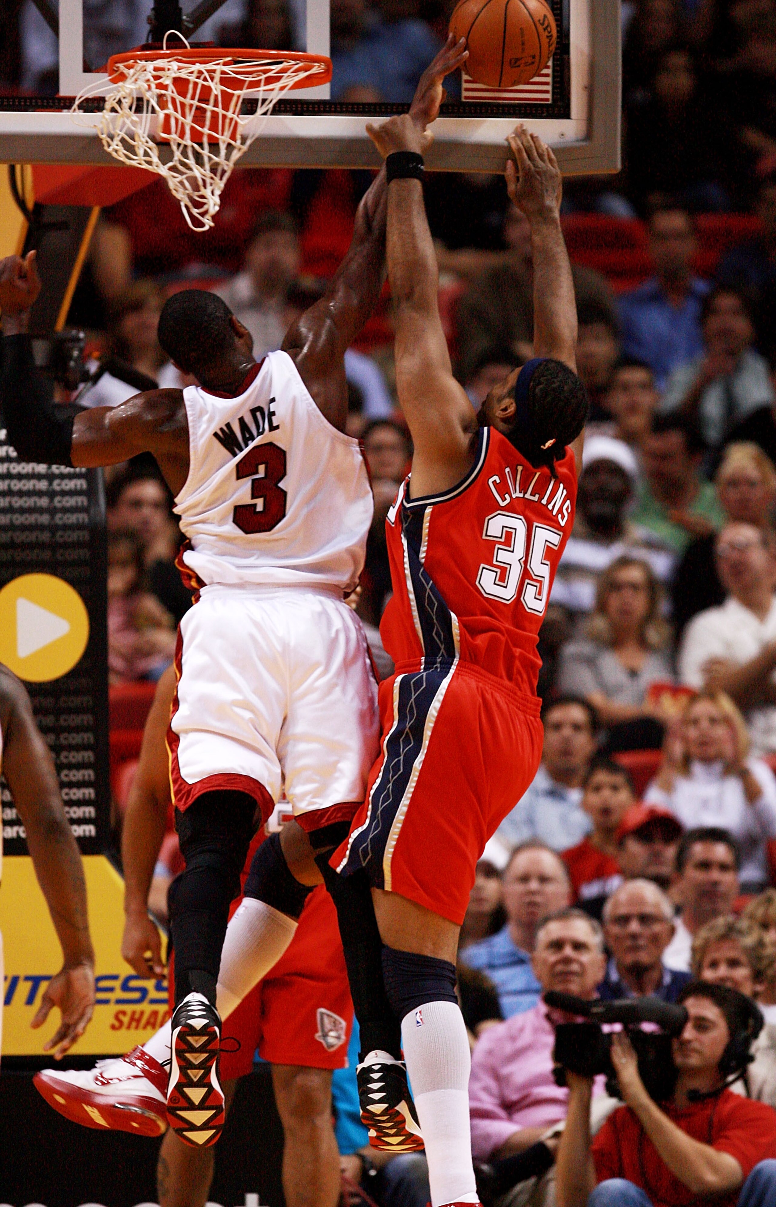 MIAMI - DECEMBER 20:  Dwyane Wade #3 of the Miami Heat blocks a shot attempt by Jason Collins #35 of the New Jersey Nets at American Airlines Arena on December 20,  2007 in Miami, Florida.  NOTE TO USER: User expressly acknowledges and agrees that, by dow