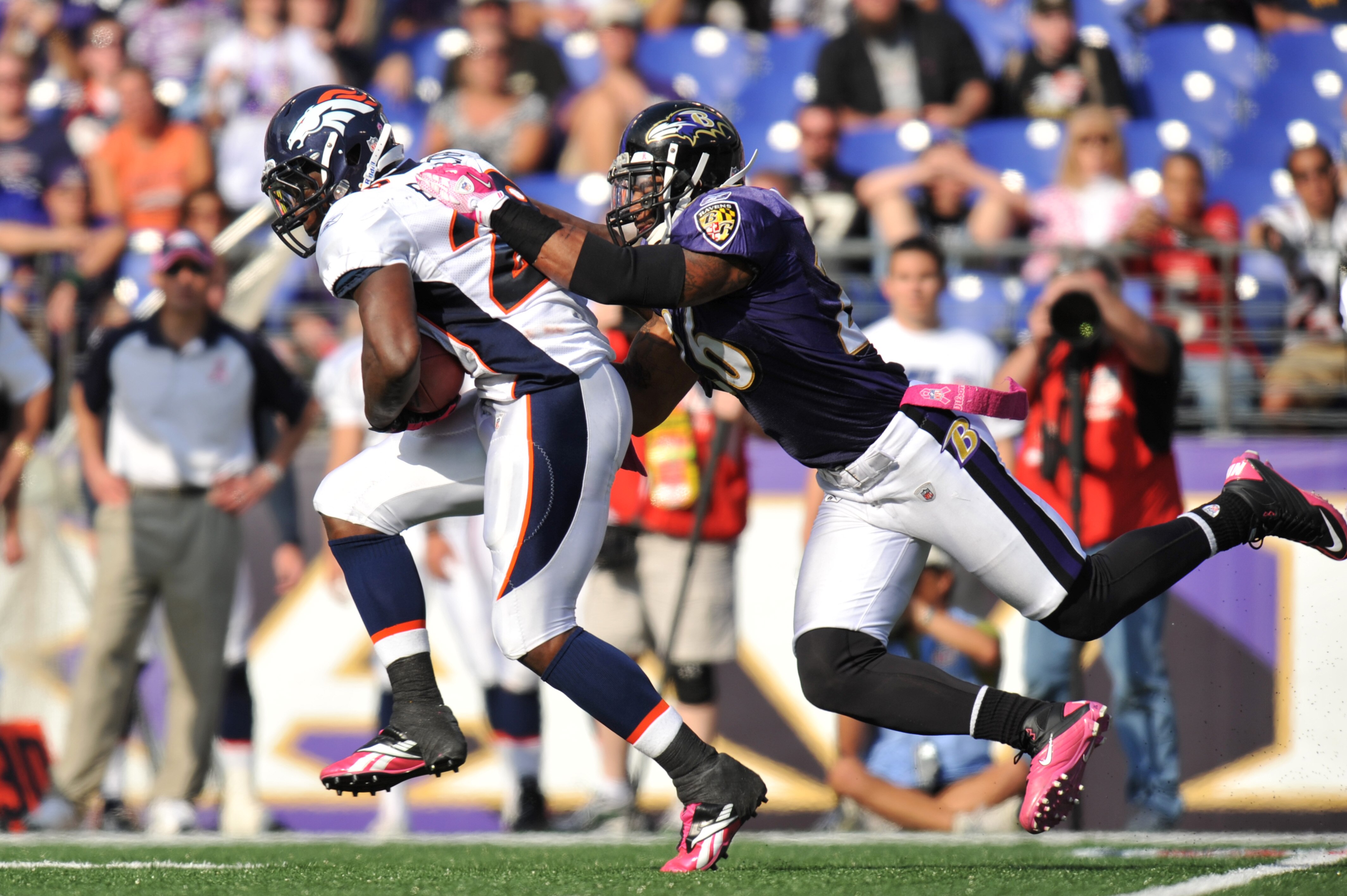 BALTIMORE, MD - OCTOBER 10:  Correll Buckhalter #28 of the Denver Broncos runs the ball against the Baltimore Ravens while Dawan Landry #26 defends at M&T Bank Stadium on October 10, 2010 in Baltimore, Maryland. Players wore pink in recognition of Breast