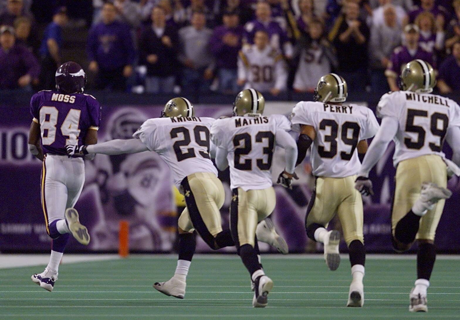06 Jan 2001:  Wide receiver Randy Moss #84 of the Minnesota Vikings takes off on a 68-yard touchdown reception with the New Orleans Saints defense in tow during the third quarter at the Metrodome in Minneapolis, Minnesota.   The Vikings won 34-16 to advan