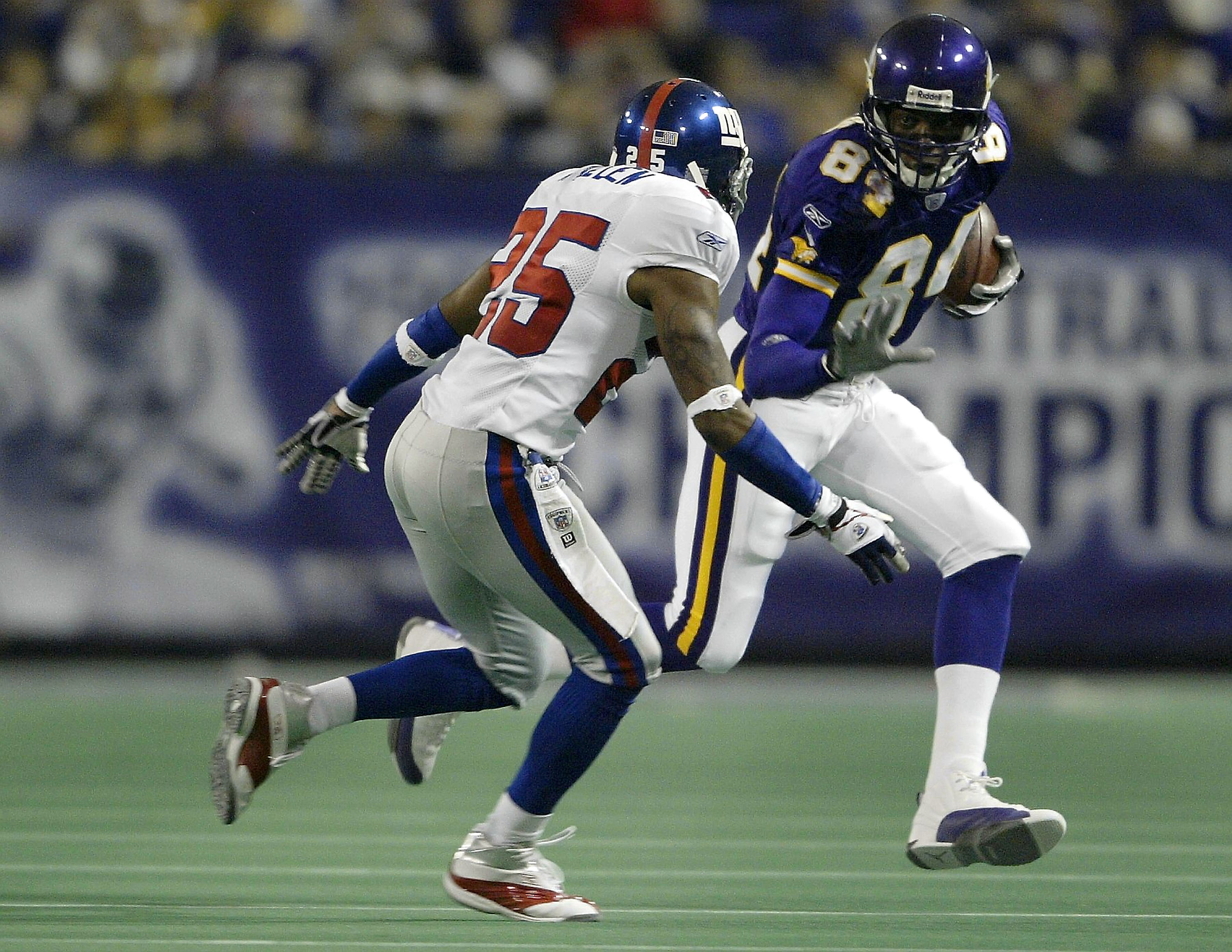 MINNEAPOLIS - OCTOBER 26:  Randy Moss #84 of the Minnesota Vikings tries to get around Will Allen #25 of the New York Giants on October 26, 2003 at the Hubert H. Humphrey Metrodome in Minneapolis, Minnesota. The New York Giants defeated the Minnesota Viki