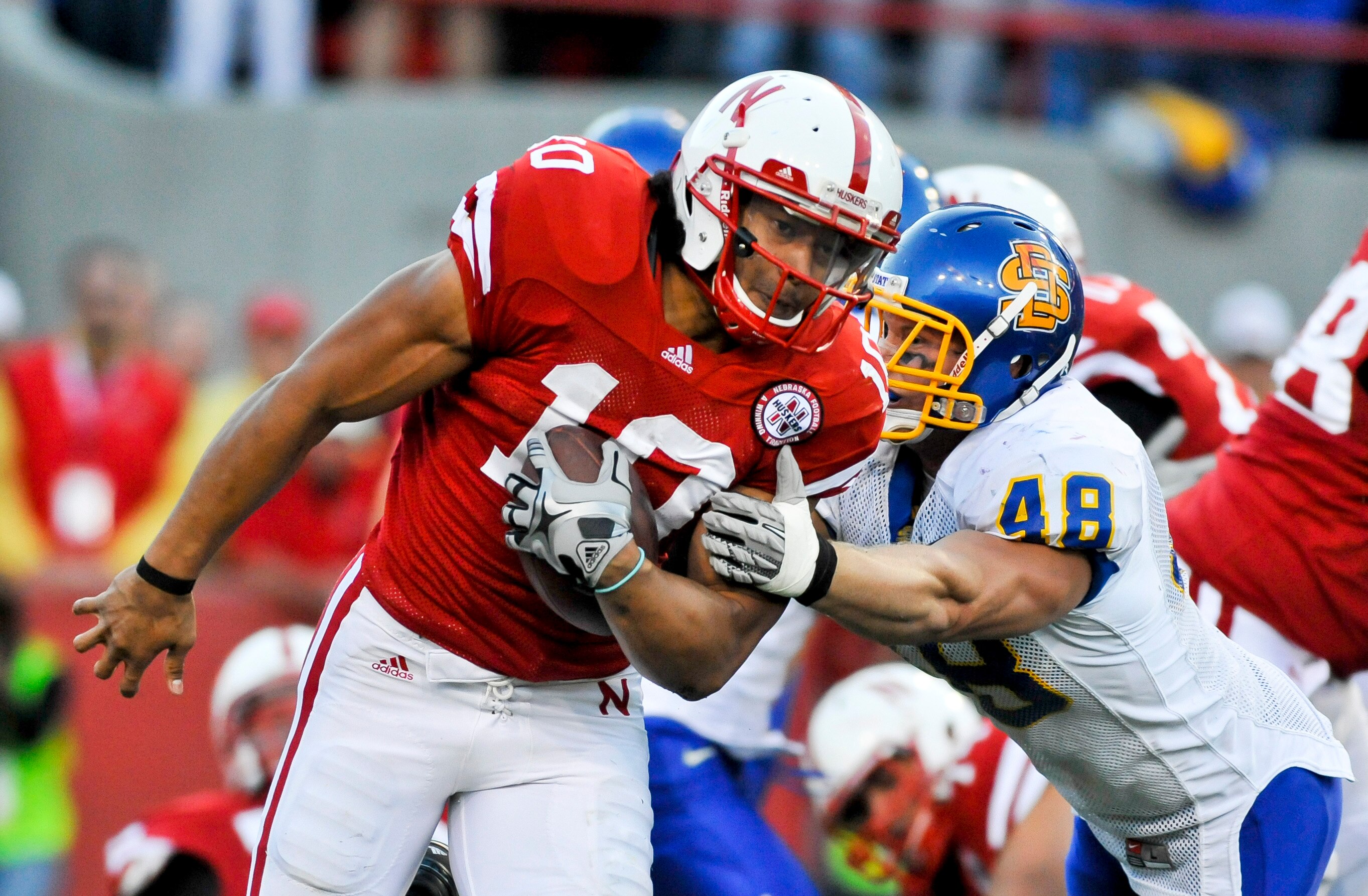 LINCOLN, NEBRASKA - SEPTEMBER 25: Nebraska Cornhuskers running back Roy Helu Jr. #10 South Dakota State Jackrabbits linebacker Dirk Kool #48 during first half action of their game against  at Memorial Stadium on September 25, 2010 in Lincoln, Nebraska. Ne
