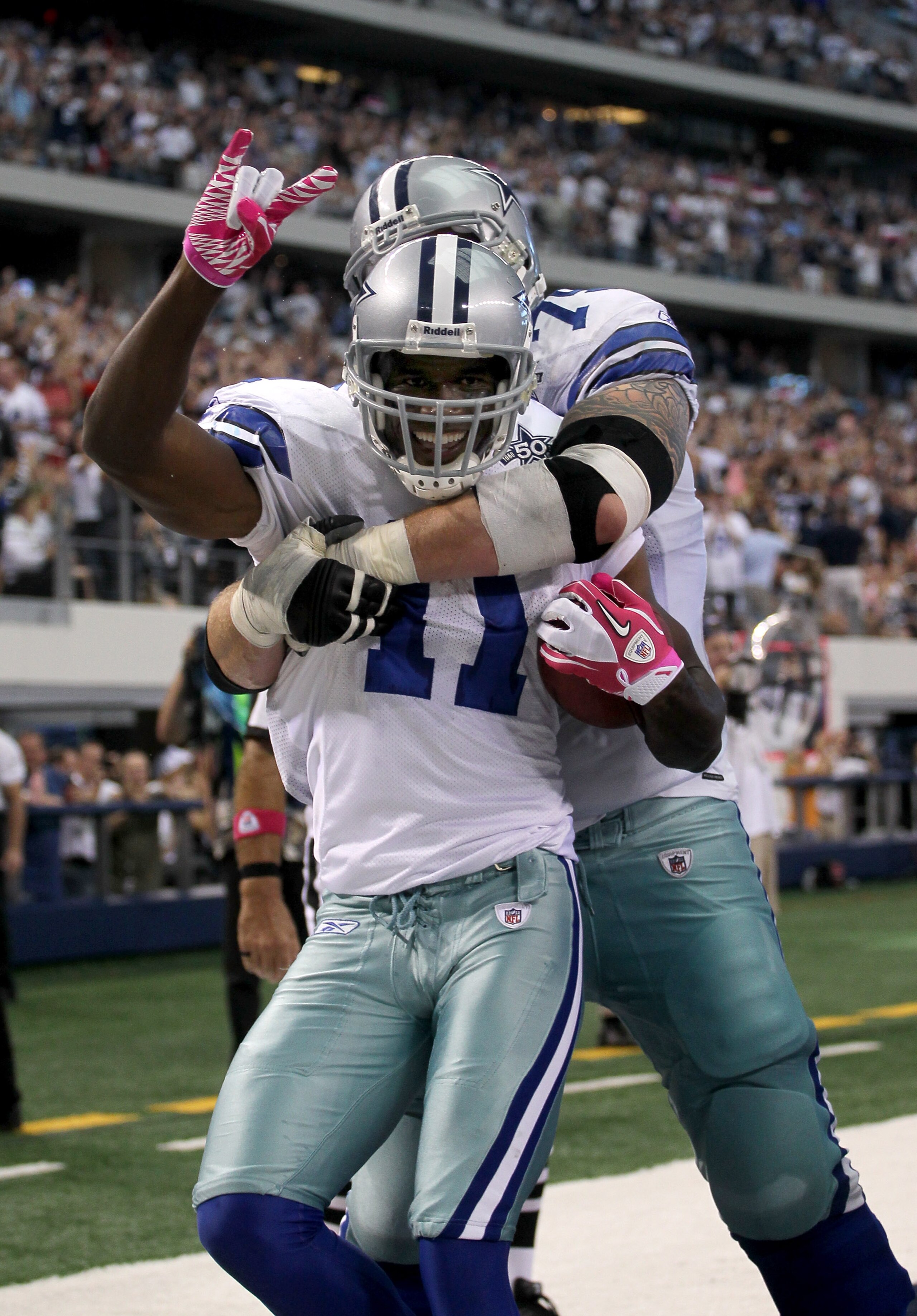 ARLINGTON, TX - OCTOBER 10: Wide receiver Roy Williams #11 of the Dallas Cowboys is hugged by tackle Marc Colombo #75 after making a six yard touchdown reception in the second quarter against the Tennessee Titans at Cowboys Stadium on October 10, 2010 in