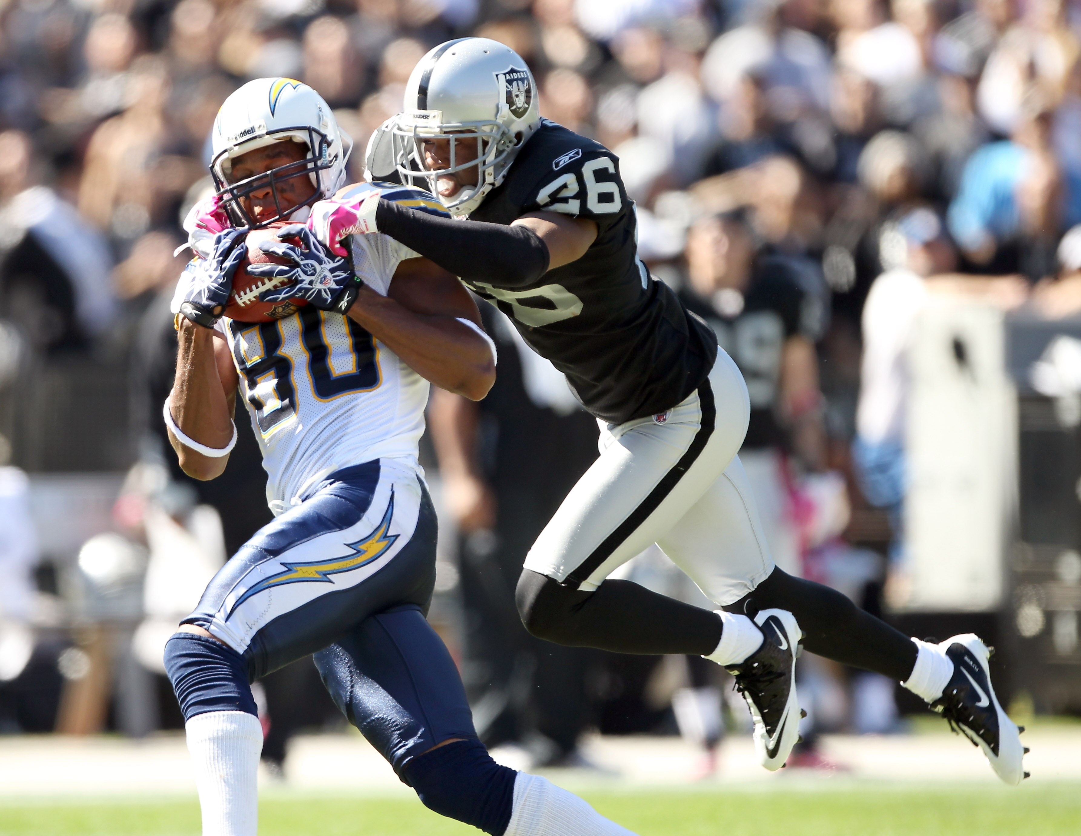 OAKLAND, CA - OCTOBER 10: Malcom Floyd #80 of the San Diego Chargers catches a ball while defended by Stanford Routt #26 of the Oakland Raiders at Oakland-Alameda County Coliseum on October 10, 2010 in Oakland, California. (Photo by Ezra Shaw/Getty Imag OAKLAND, CA - OCTOBER 10: Malcom Floyd #80 of the San Diego Chargers catches a ball while defended by Stanford Routt #26 of the Oakland Raiders at Oakland-Alameda County Coliseum on October 10, 2010 in Oakland, California. (Photo by Ezra Shaw/Getty Imag
