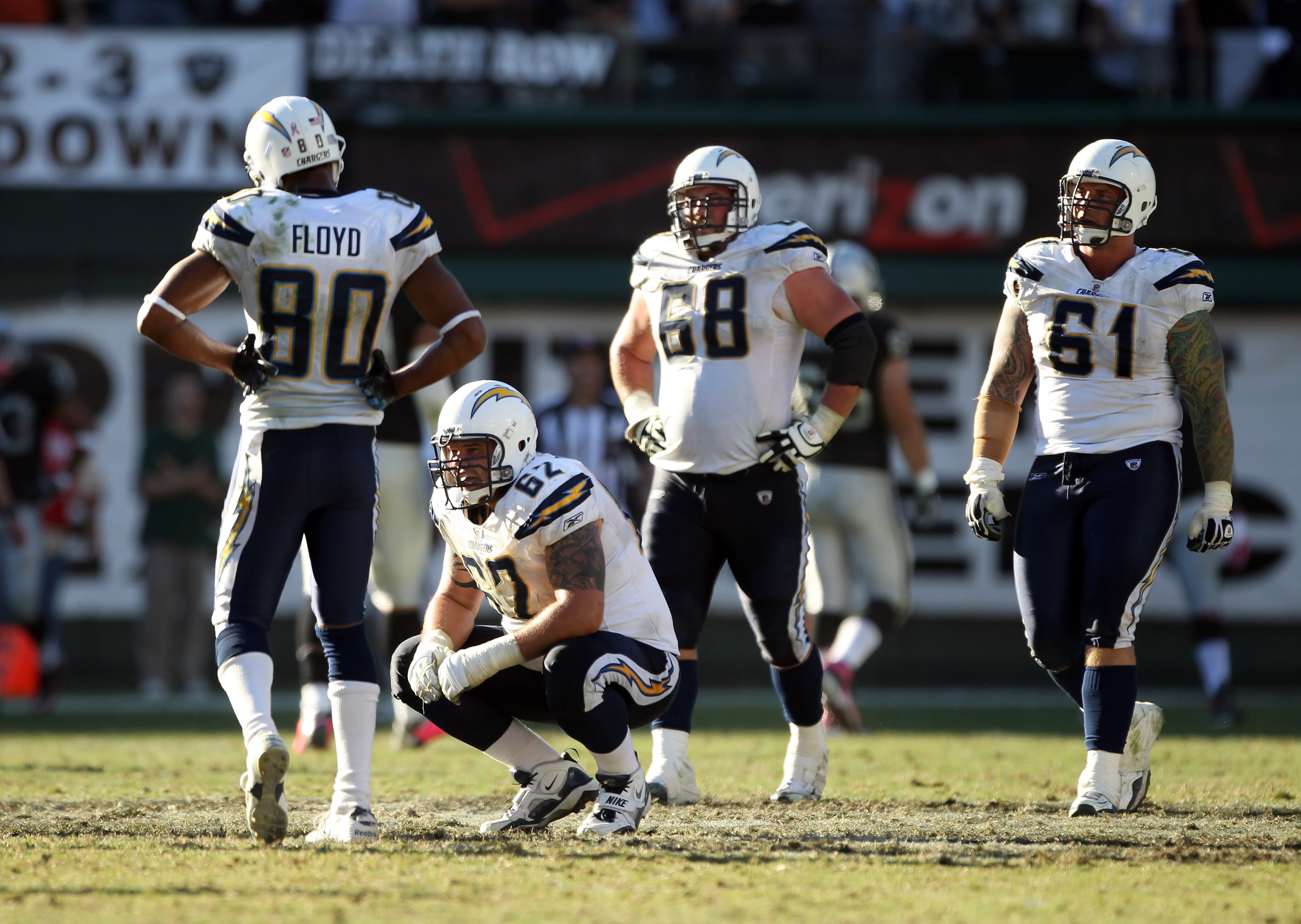 OAKLAND, CA - OCTOBER 10: Malcom Floyd #80, Brandyn Dombrowski #62, Kris Dielman #68 and Nick Hardwick #61 of the San Diego Chargers react after Tyvon Branch #33 of the Oakland Raiders picked up a fumble and returned it for a touchdwon in the fourth qua OAKLAND, CA - OCTOBER 10: Malcom Floyd #80, Brandyn Dombrowski #62, Kris Dielman #68 and Nick Hardwick #61 of the San Diego Chargers react after Tyvon Branch #33 of the Oakland Raiders picked up a fumble and returned it for a touchdwon in the fourth qua