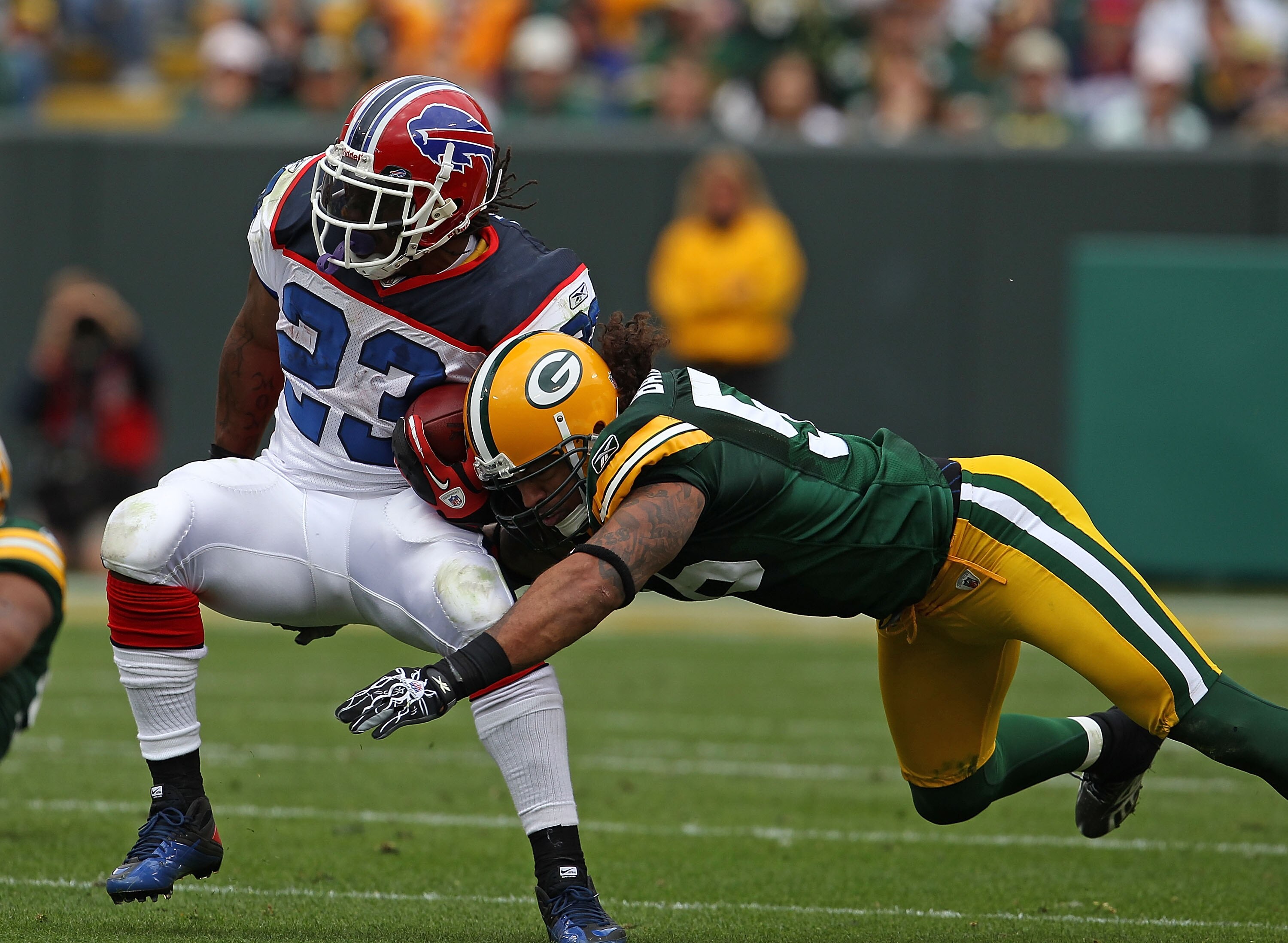 GREEN BAY, WI - SEPTEMBER 19: Nick Barnett #56 of the Green Bay Packers tackles Marshawn Lynch #23 of the Buffalo Bills at Lambeau Field on September 19, 2010 in Green Bay, Wisconsin. The Packers defeated the Bills 34-7. (Photo by Jonathan Daniel/Getty Im