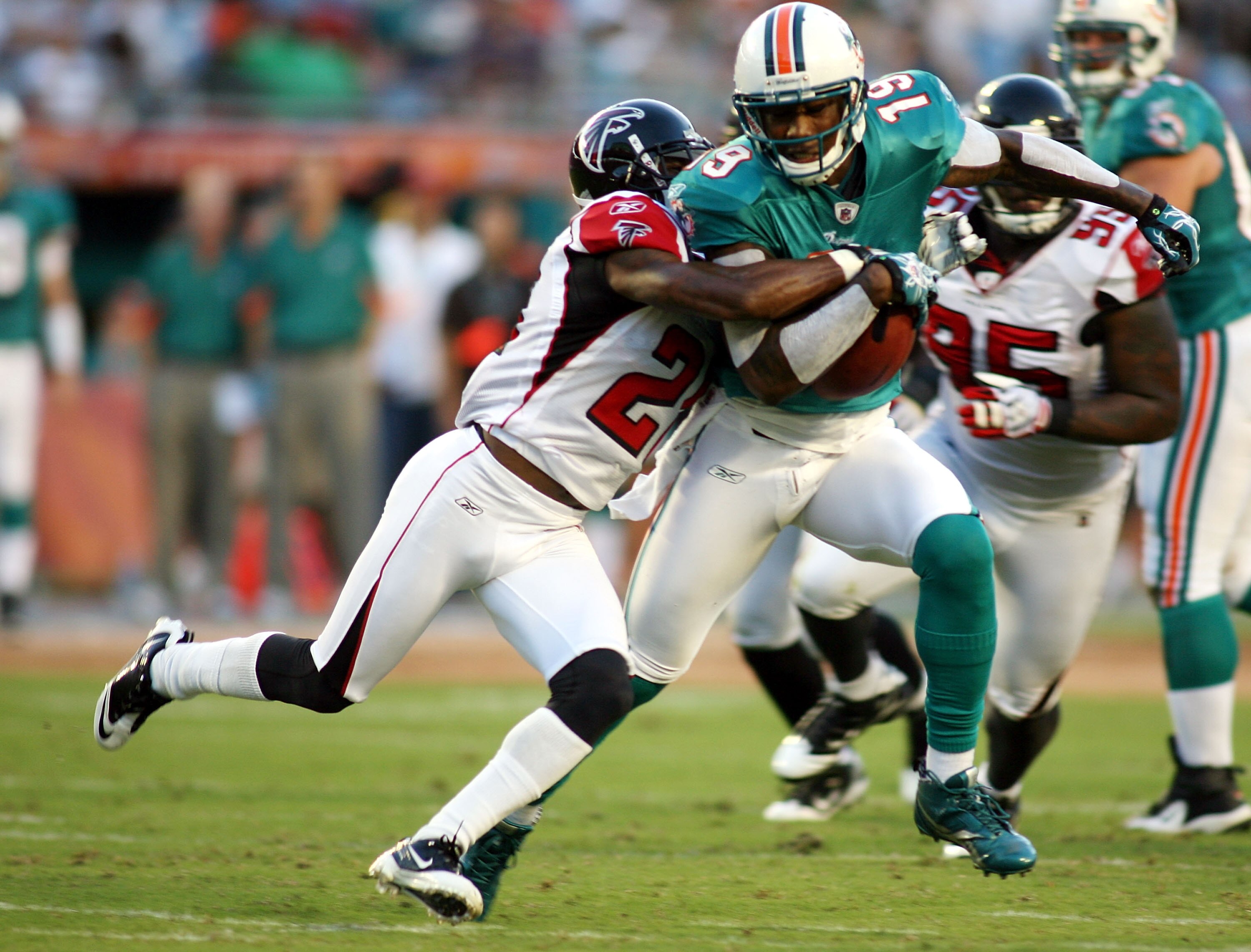 MIAMI - AUGUST 27:  Wide reciever Brandon Marshall #16 of the Miami Dolphins runs with the ball  against cornerback Brent Grimes #20 of the Atlanta Falcons during their preseason game at Sun Life Stadium on August 27, 2010 in Miami, Florida.  (Photo by Ma