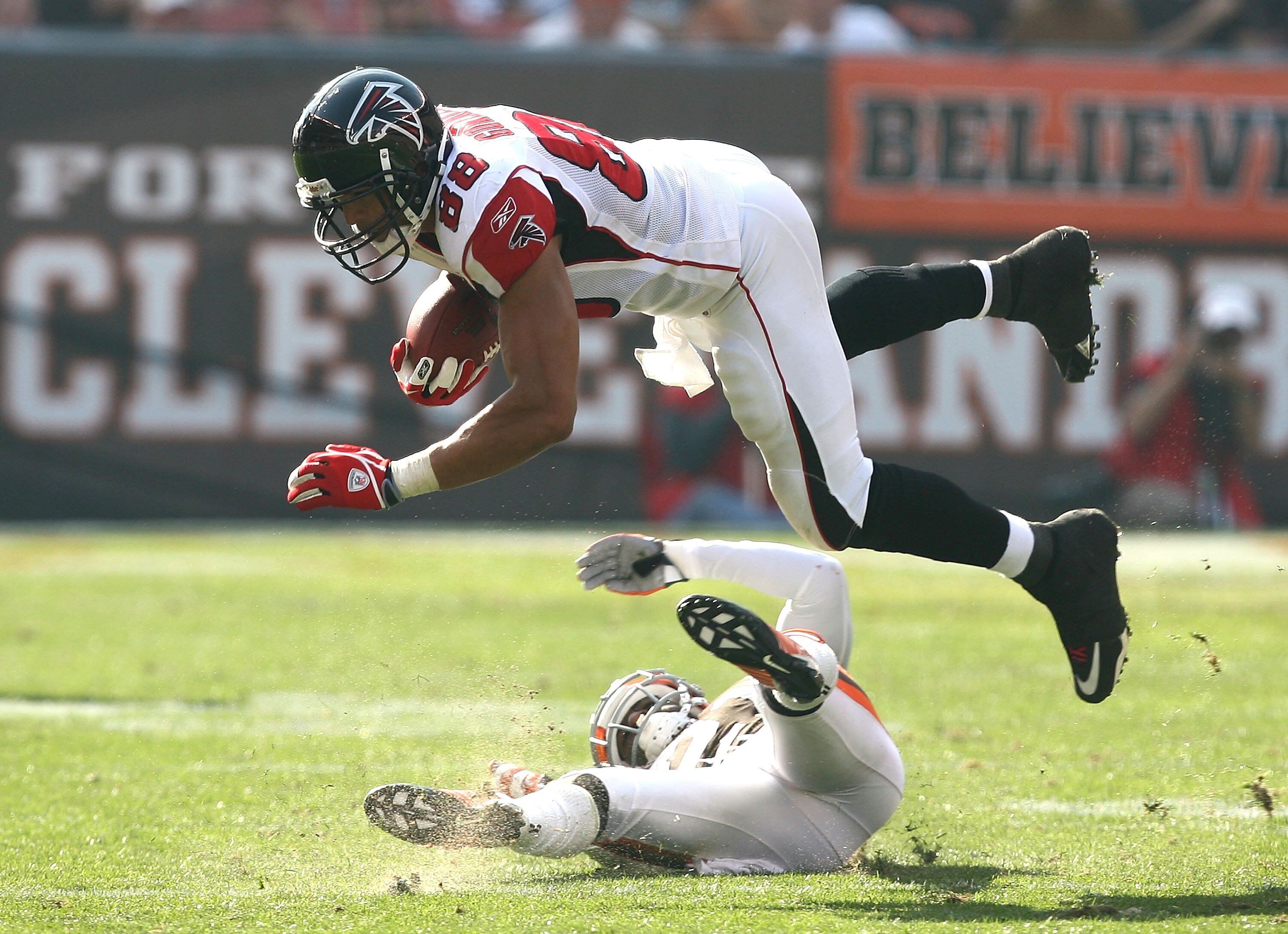 CLEVELAND - OCTOBER 10:  Tight end Tony Gonzalez #88 of the Atlanta Falcons dives over defensive back Eric Wright #21 of the Cleveland Browns at Cleveland Browns Stadium on October 10, 2010 in Cleveland, Ohio.  (Photo by Matt Sullivan/Getty Images)